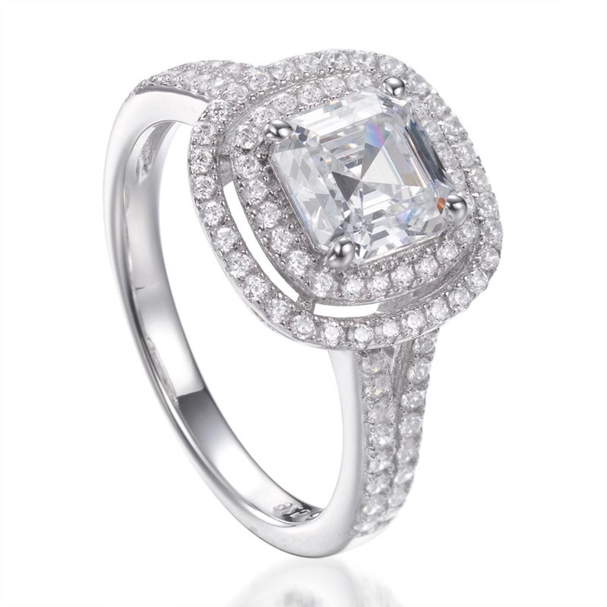 This elegant double halo ring showcases a stunning claw set centre Asscher cut cubic zirconia measuring 2.85 carat, surrounded by a double row of dazzling round brilliant cut cubic zirconia, exquisitely set into a split shank. 

Composed of 925