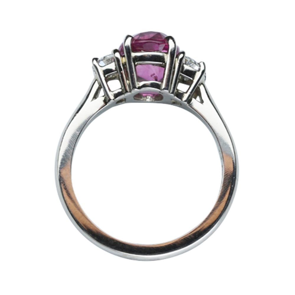 Elegant & finely detailed Solitaire Cocktail Engagement Ring, set with a securely nestled  2.85 Carat Intense Pink oval Sapphire, clarity: VS; internally flawless (IF); dimensions: 9.0mm x 7.0mm, either side set with Brilliant-cut Diamonds,