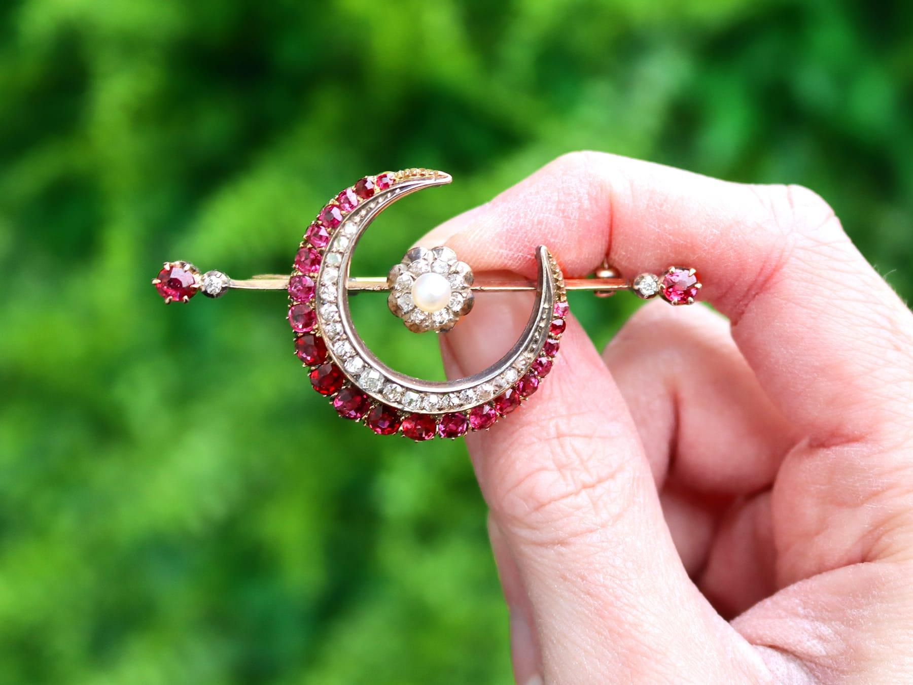 An exceptional, fine and impressive antique 2.85 carat natural ruby, 0.65 carat diamond and pearl, 9k yellow gold, silver set crescent, bar style brooch; part of the antique jewelry / estate jewelry collections.

This antique crescent brooch has