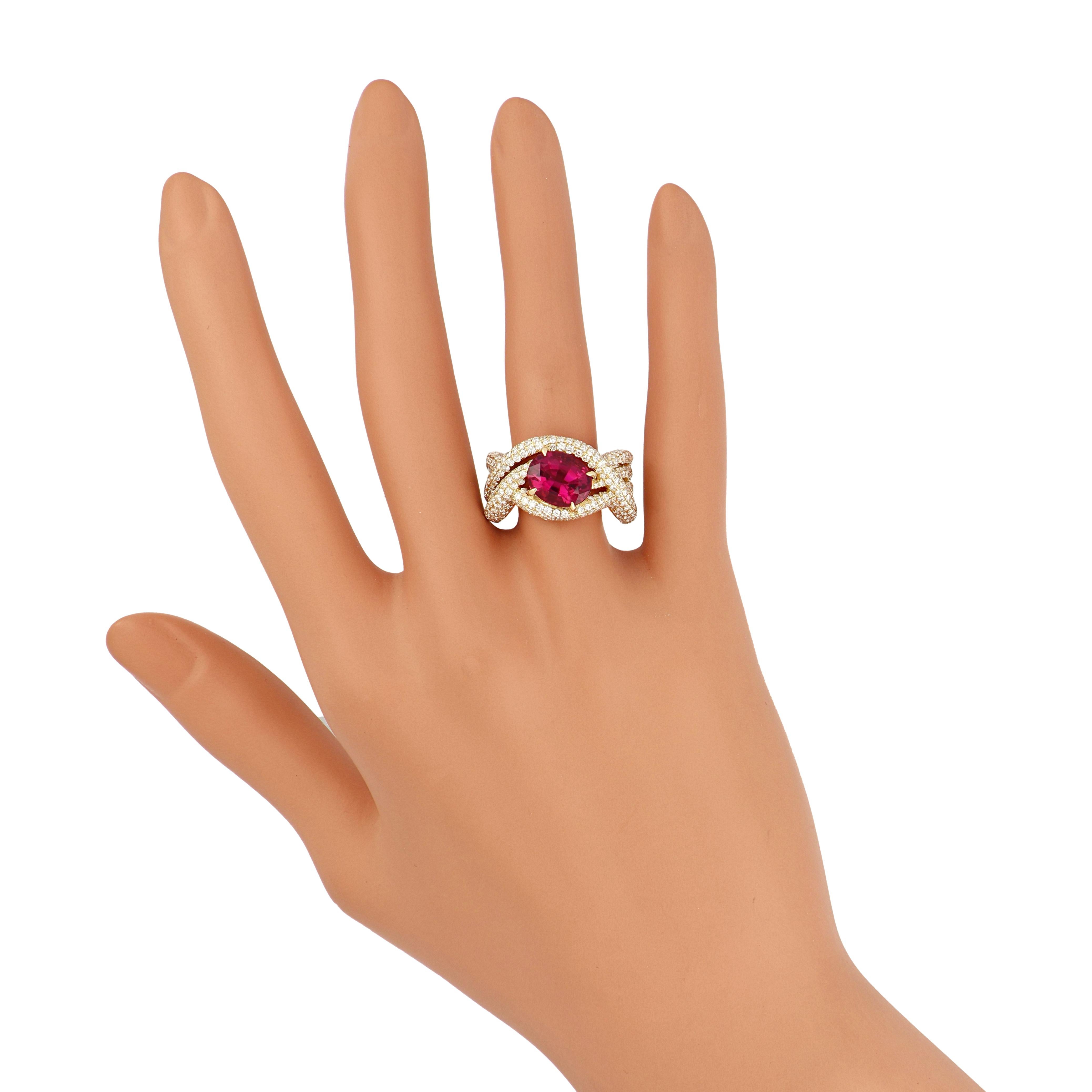 Delve into the epitome of opulence with our exquisitely crafted 18 karat Yellow Gold Ring. Adorned with a resplendent 2.8 carat (approx.) Oval Shape Rubellite as its centrepiece, this masterpiece is embraced by a mesmerising ensemble of diamonds,