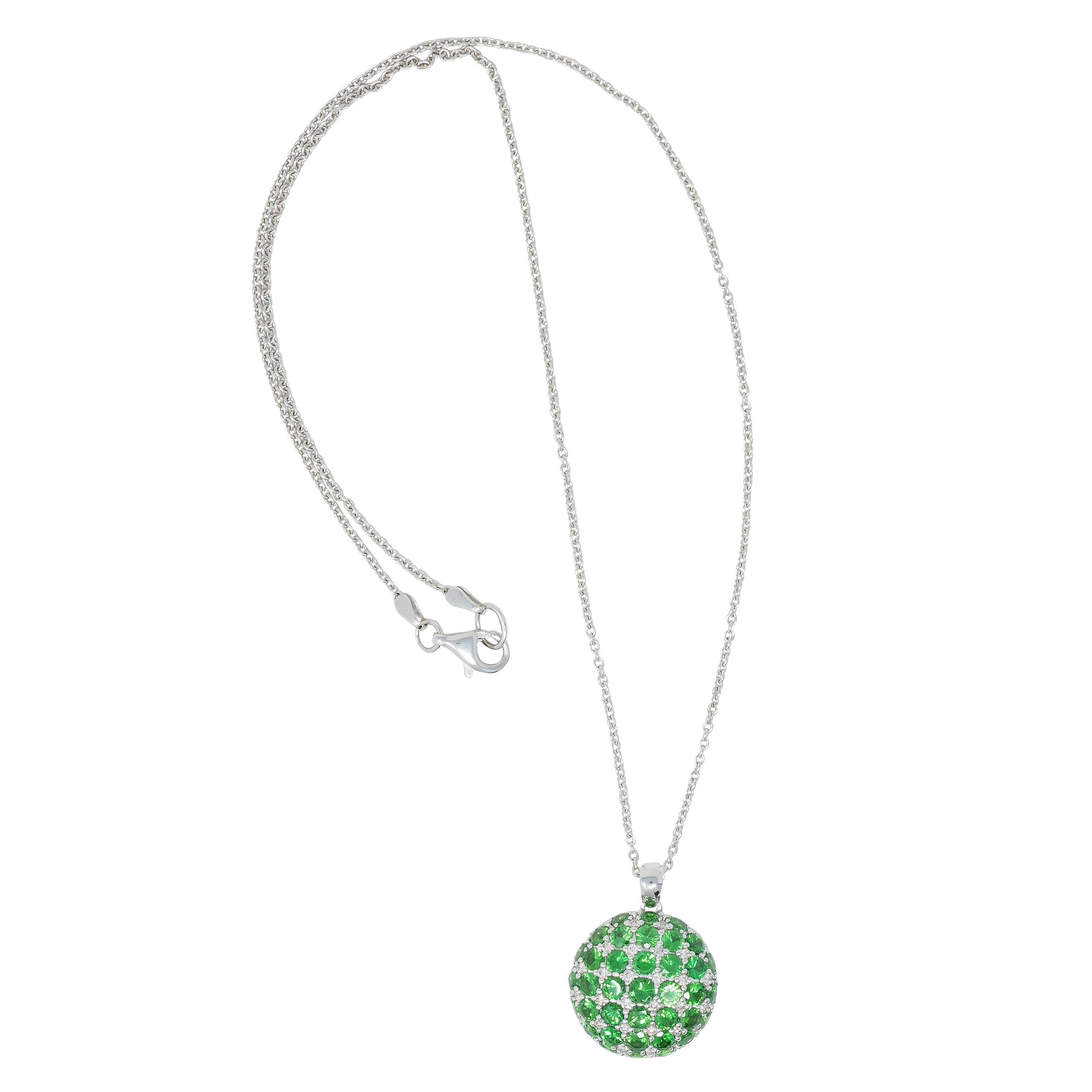 Comprised of 1.0 mm cable link chain suspending a round domed pendant 
Pavé set throughout with round cut demantoid garnets 
Weighing approximately 2.85 carats total 
Transparent medium green in color 
Reverse is pierced with grid motif
Suspending