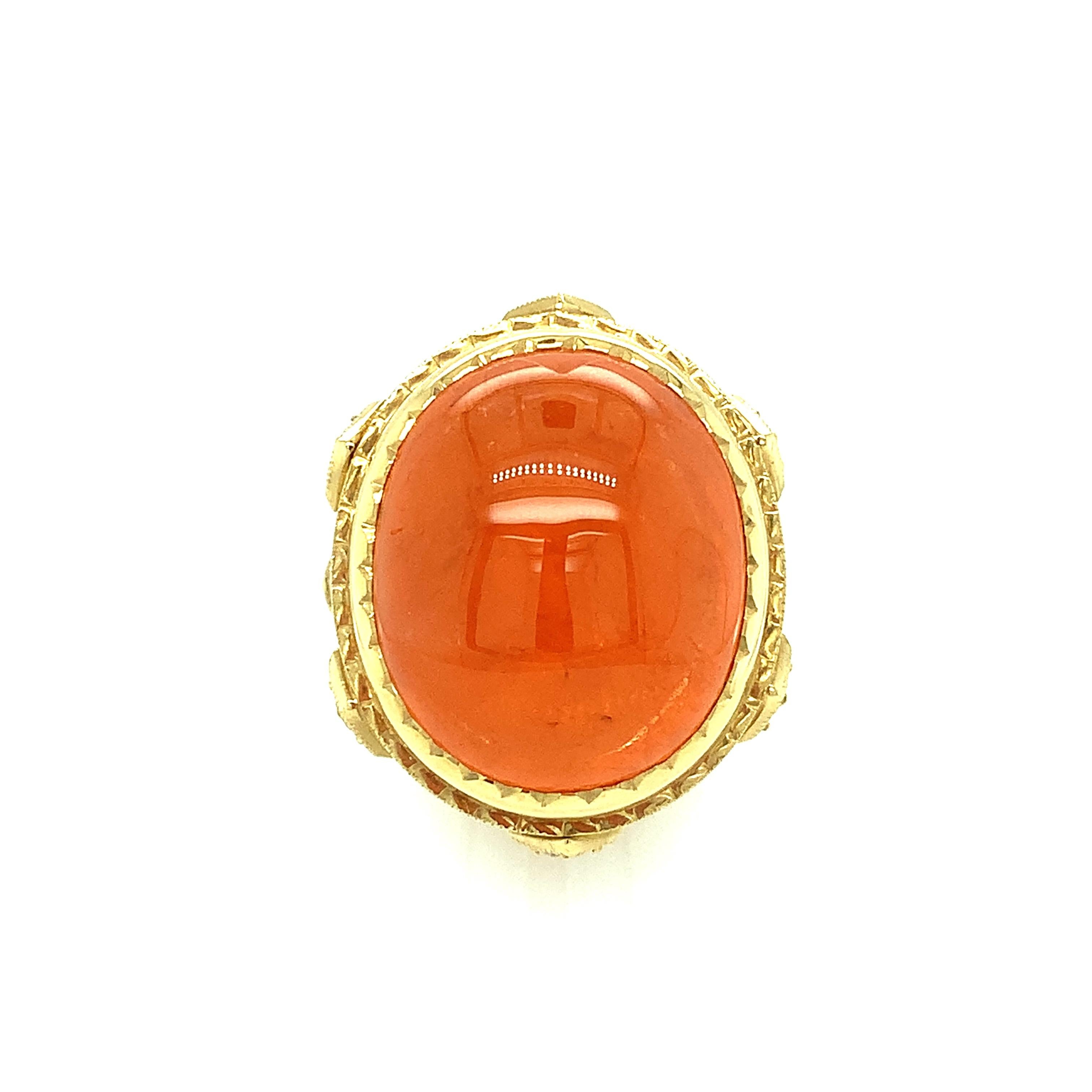 Big, bright, and beautiful! This gorgeous ring features a rare, giant, mandarin orange spessartite garnet cabochon that is so perfect, it looks like a piece of candy! It is bezel set in a regal-looking, 18k yellow gold ring that displays a level of