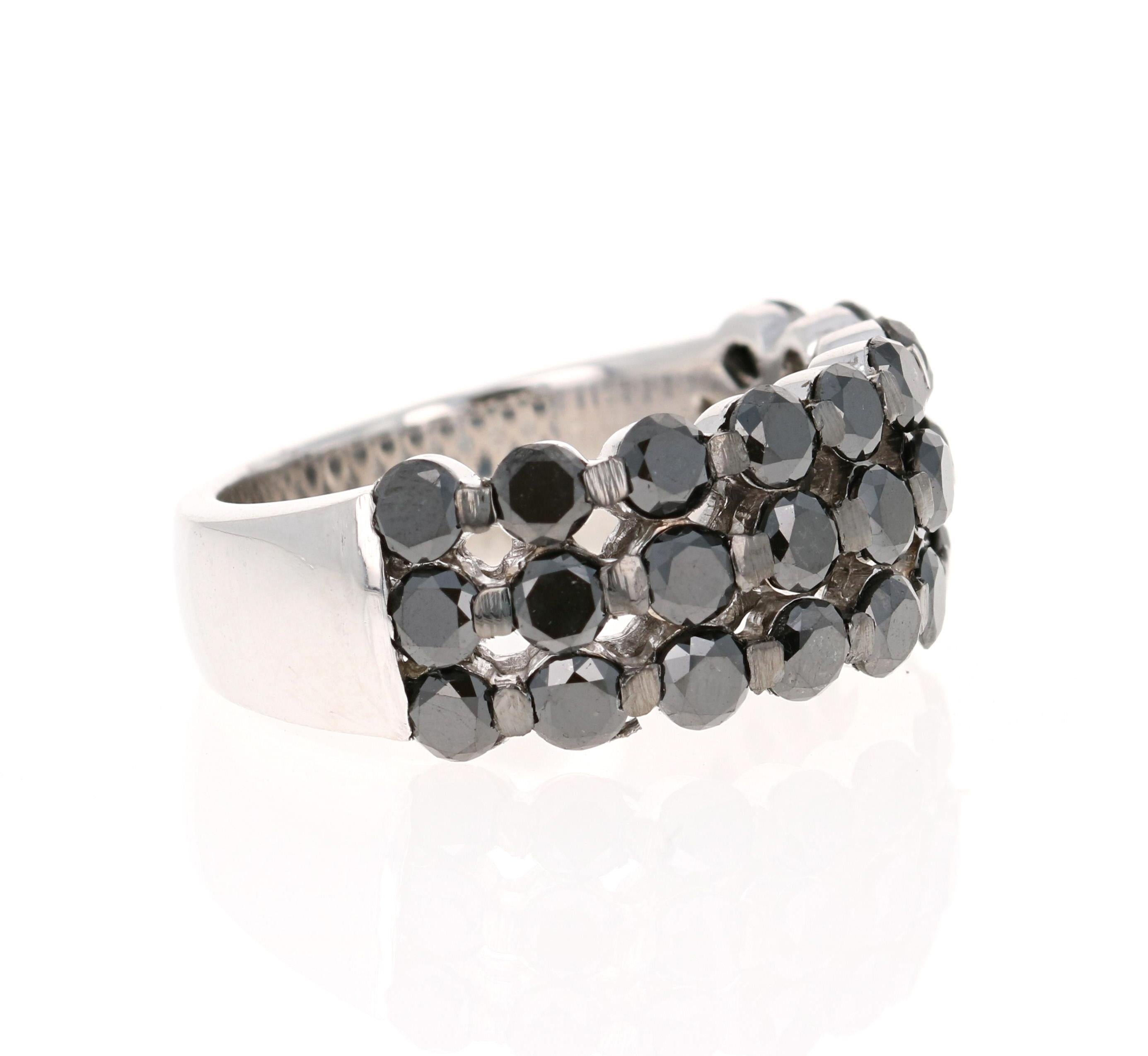 This ring has 27 Natural Rount Cut Black Diamonds that weigh 2.86 carats. 
The black diamonds are natural and are color treated to attain its black color. 

It is set in 14 Karat White Gold and has a weight of approximately 7.5 grams. 
The width of