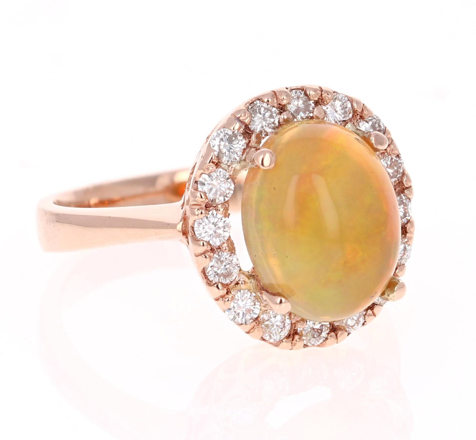 Beautiful and Cute! Who would have thought something so simple can be so sweet! This Opal and Diamond Ring is made in a 14K Rose Gold setting. It has an Ethiopian Oval Cut Opal which weighs 2.38 carats and is surrounded by a simple halo of 16 Round