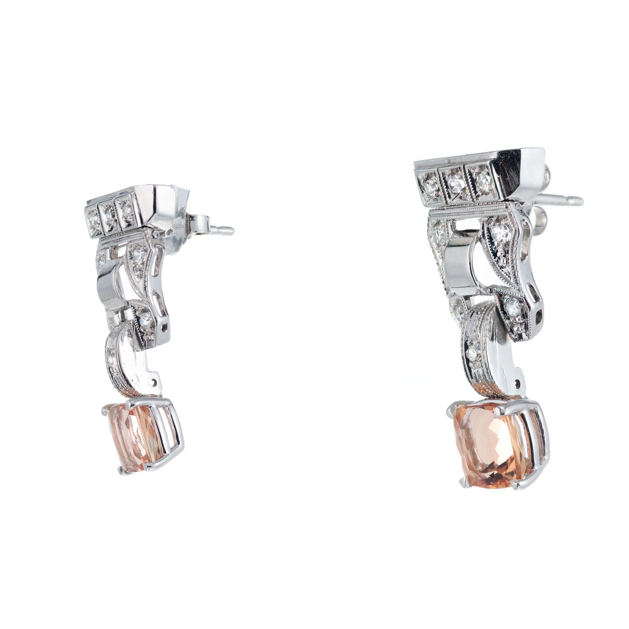 Untreated pink orange precious cushion cut pink Topaz dangle earrings set in 14k white gold with 16 single cut accent diamonds. 

2 pink cushion cut precious Topaz, approx. total weight 2.86cts, VS, 6.2 x 6.2mm, natural and untreated
16 single cut
