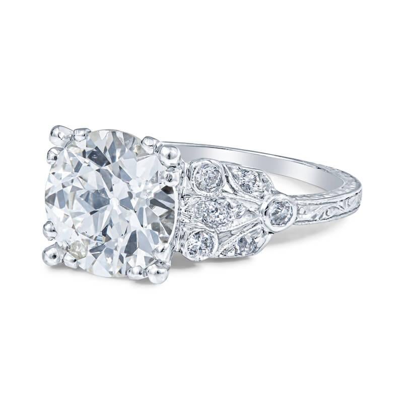 Elegant lady’s antique engagement ring in platinum featuring a 2.86 carat old European cut round diamond with a J color grade set between 0.18 carats of round cut diamonds . Set in a platinum mounting, this ring embellishes the antique qualities