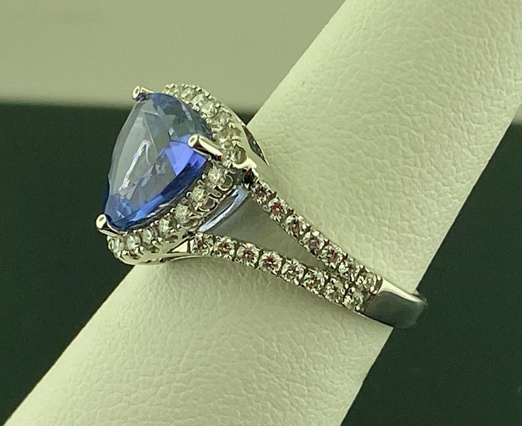 Set in 14 karat white gold, weighing 3.45 grams, is one 2.86 carat Trillion cut Tanzanite, with 58 Round Brilliant Cut diamonds weighing approximately 0.58 carats.  Color: E-F, Clarity: VVS.  Ring size is 5.25.