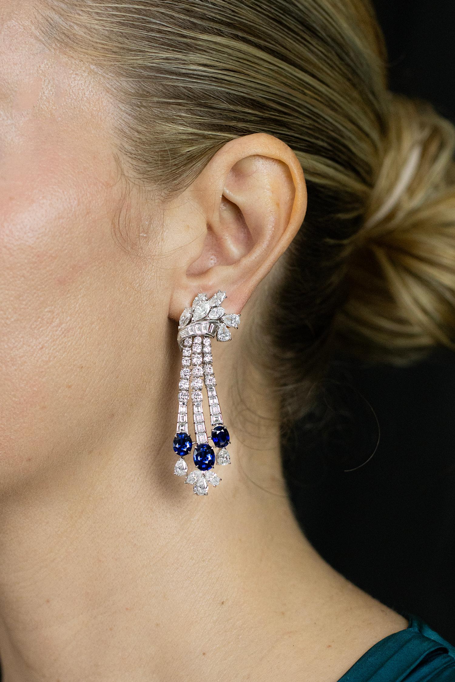 A pair of stunning and important dangle earrings, featuring six oval cut sapphires weighing 10.18 carats total. Accented with mixed-cut diamonds weighing 18.45 carats total. A gorgeous pair of earrings with a drop design, set beautifully on 18K