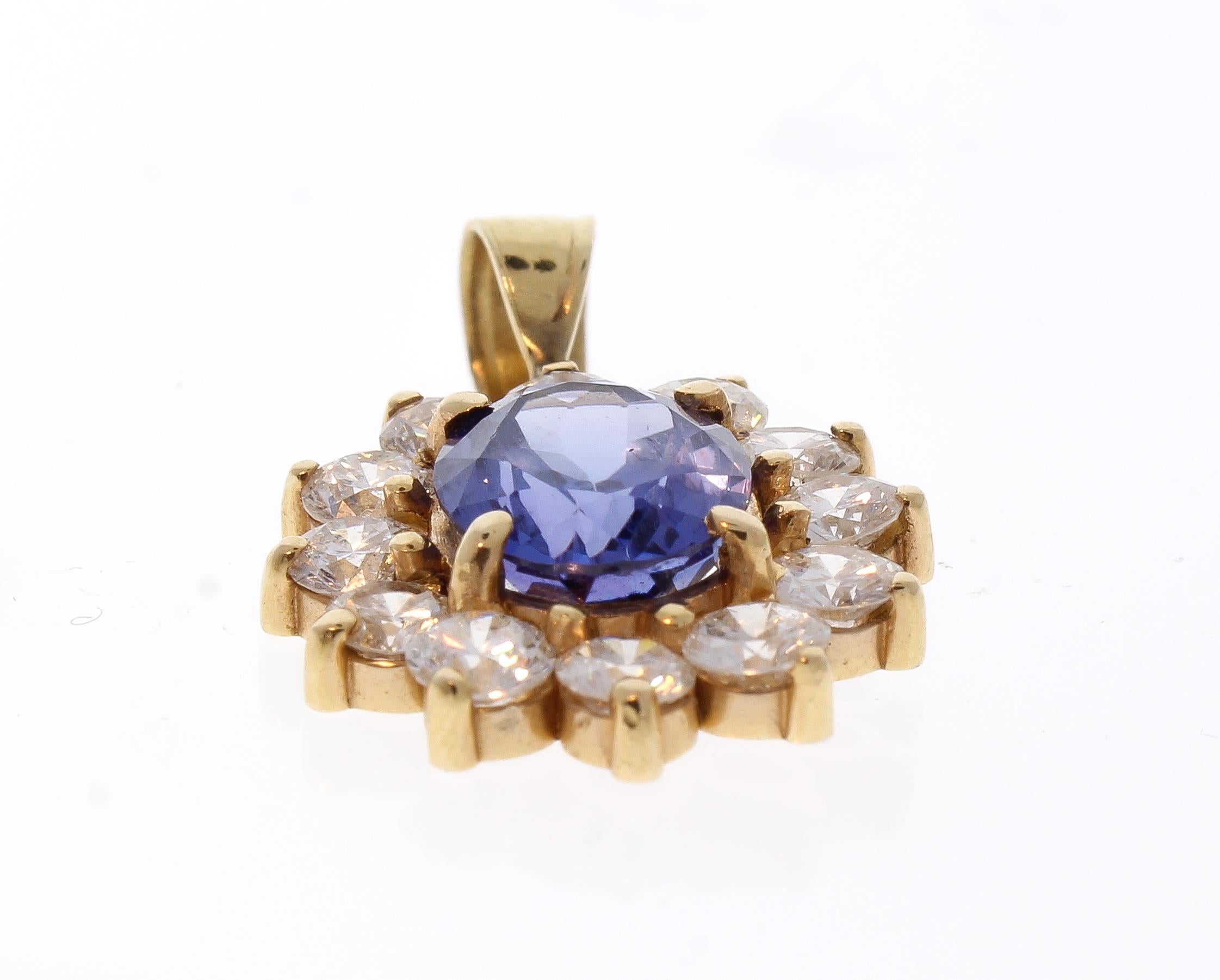 Add this captivating detail to any ensemble and it will elevate your look to new heights. This stunning pendant features an illuminating 2.87 carat oval tanzanite, originating from Tanzania, is surrounded by a fiery halo of dazzling diamonds that