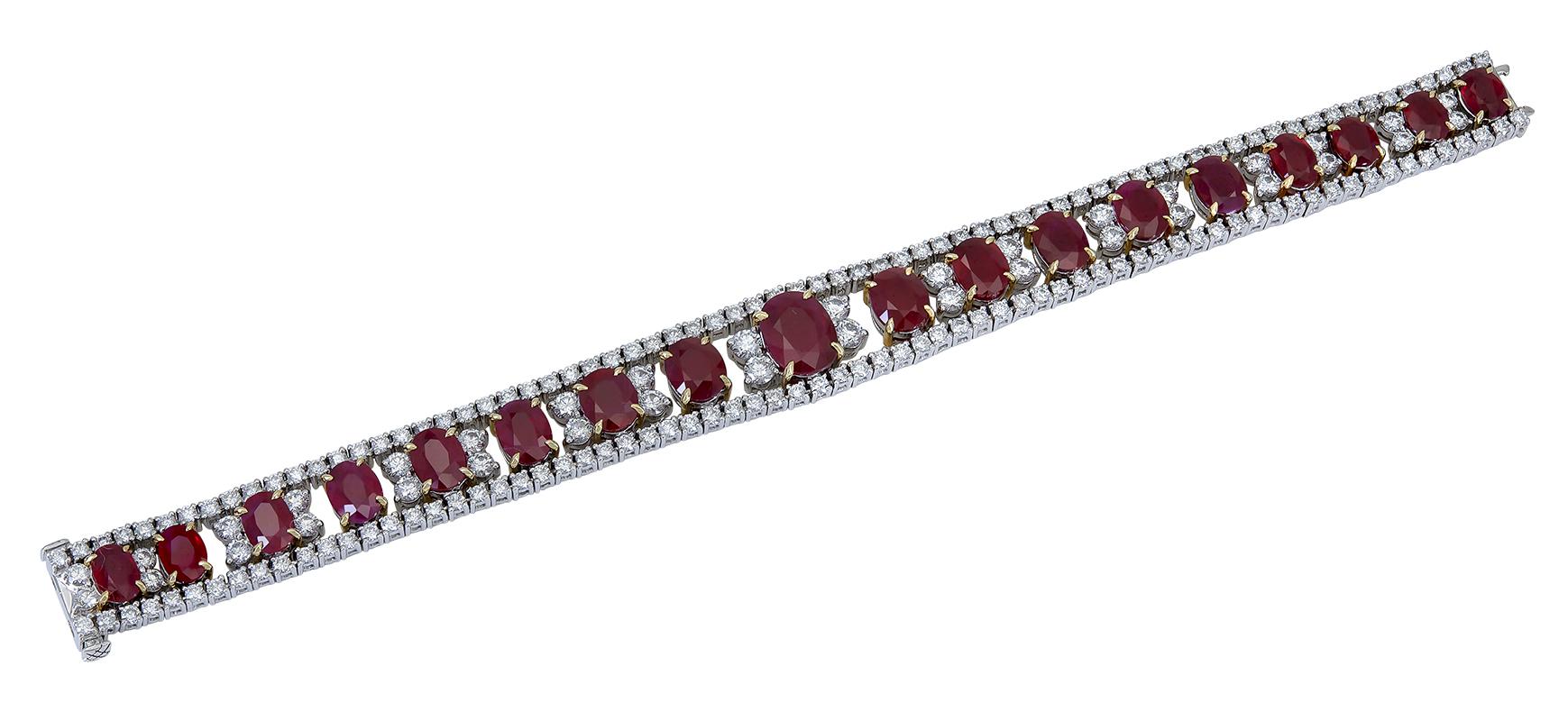 Features vibrant red oval cut rubies weighing 28.70 carats, set in an open-work design accented with round brilliant diamonds. Diamonds weigh 8.99 carats total and are approximately G-H color, VS clarity.
Rubies are heated and of Burmese