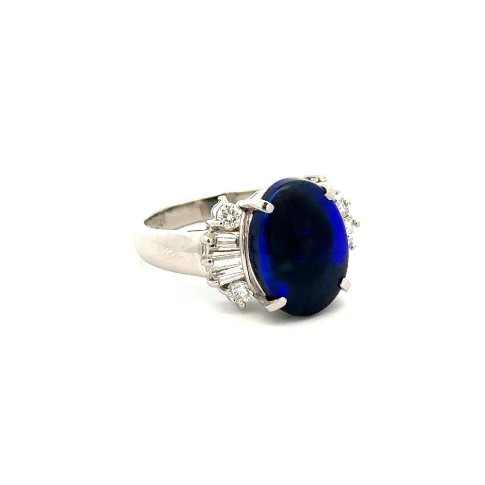 Simply Beautiful! Elegant and finely detailed, Black Opal and Diamond Platinum Ring. Centering a securely nestled Hand set Oval Black Opal, weighing approx. 2.88 Carat and surrounded by Baguette & Round Brilliant Cut Diamonds, weighing approx.
