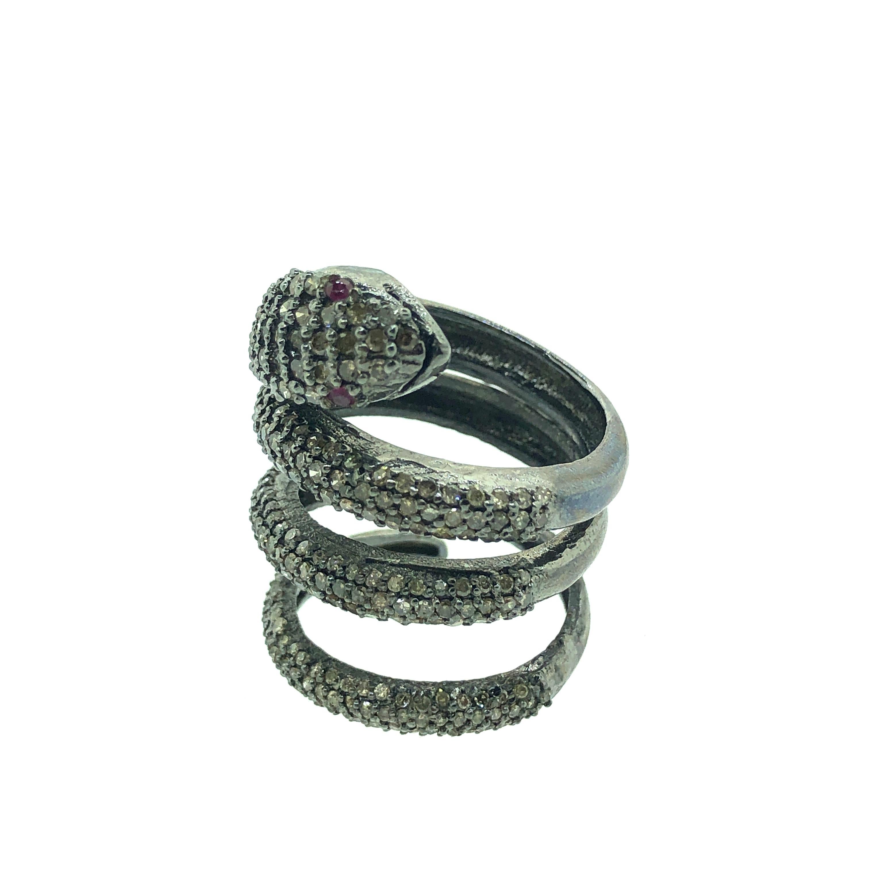 7.75 Size 2.88 ct Champagne Diamond and 0.04 ct Ruby Eyes Snake Ring set in Oxidized Sterling Silver. All the diamonds are pave diamonds with ruby eyes in the snake. A perfect cocktail ring for a person who loves snakes. 
Diamonds : 2.88 ct
Ruby :