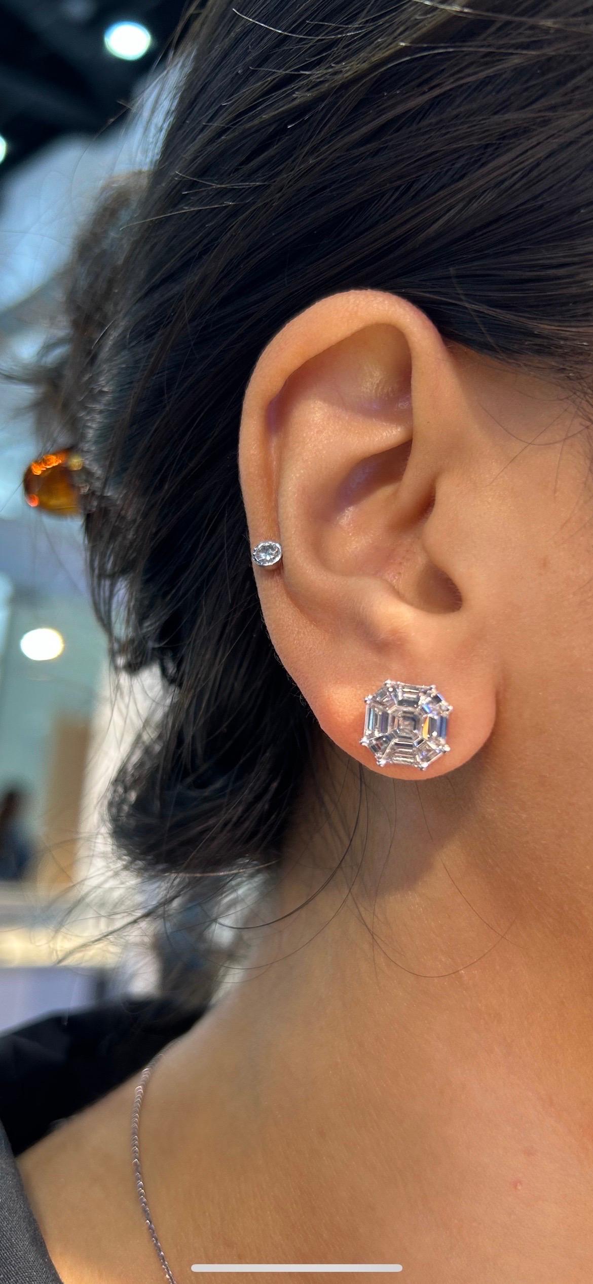 A stunning pair of 2.88 carats total F/G color, VVS/VS quality Diamond studs, set in solid 18K White Gold. The earrings look like 5 carat each square emerald cut diamonds. The pressure setting of baguettes and trapezoids are of top quality, and the