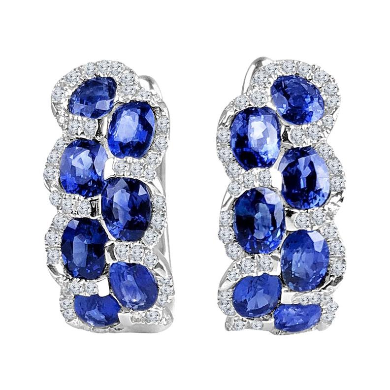 Indulge in the enchanting allure of these lever-back earrings, each adorned with seven mesmerizing oval-cut sapphires per earring, totaling an impressive 2.88 carats. The sapphires, reminiscent of the deep blue skies, are delicately nestled among a