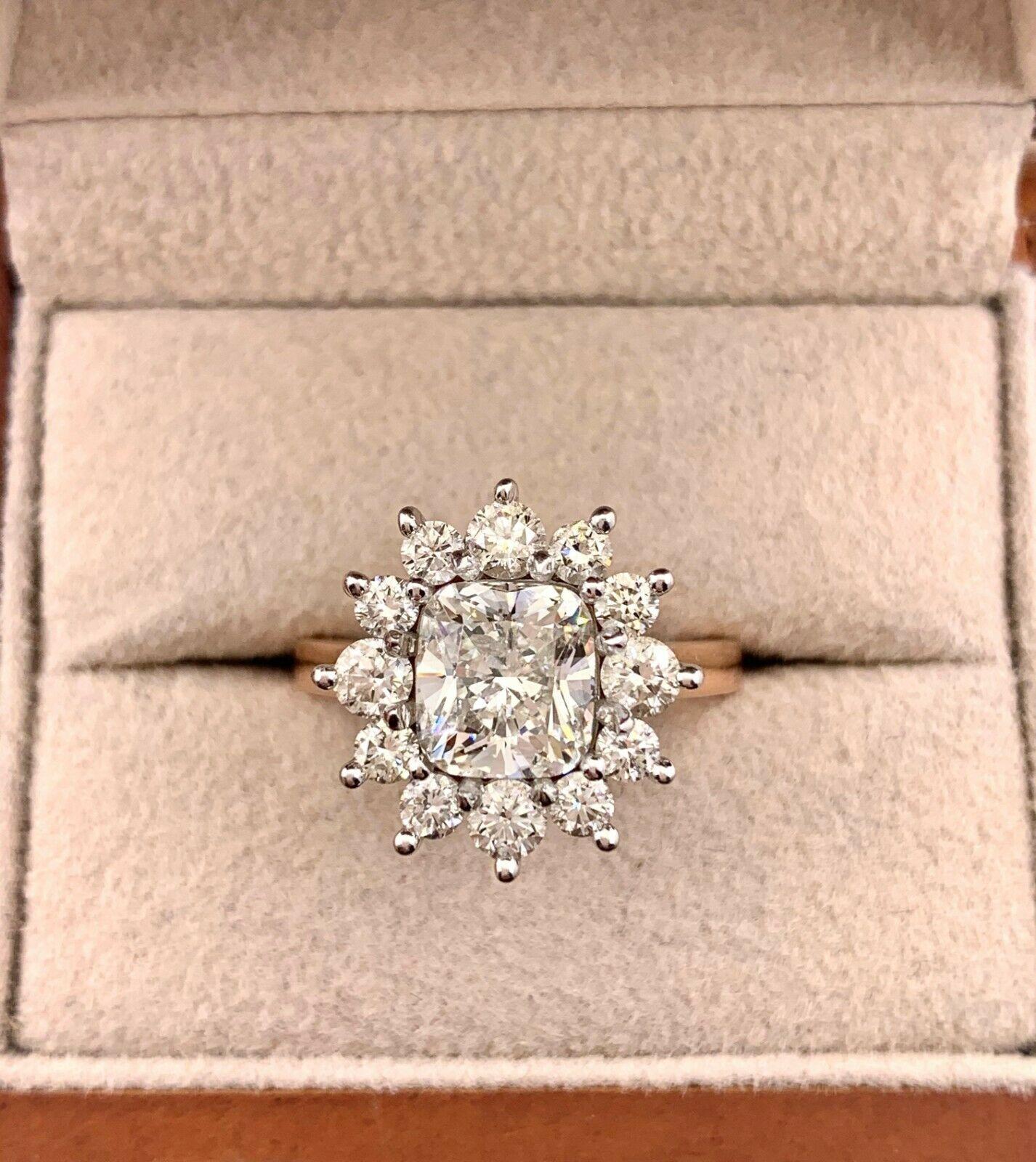 Cushion Cut Diamond Flower Ring
Style:  Custom Halo Diamond Engagement Ring
Metal: 14K Rose & White Gold
Size / Measurements:  5, sizable
TCW:  2.88 Carats Total
Main Diamond:  2.08 Carat Cushion Brilliant Cut
Color & Clarity:  J Color, SI2