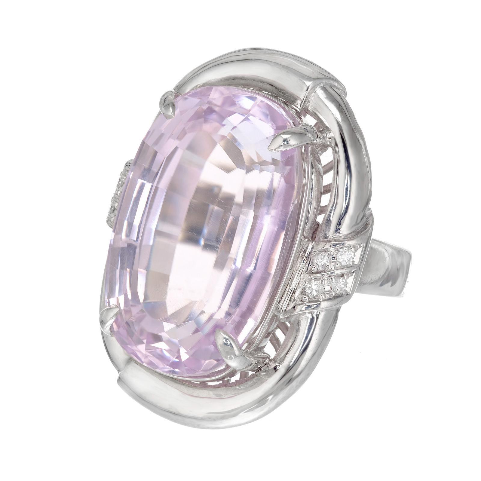 1960's bright light pink oval Kunzite and diamond cocktail ring. Large oval pink Kunzite center stone in a platinum setting with round side diamonds. 

1 Oval Kunzite, 21.57 X 13.59 X 10.95mm, Approximate 28.89cts, Pink.
8 Round Brilliant Cut