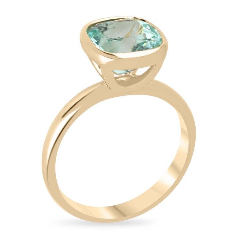 Displayed is a bespoke Colombian emerald solitaire cushion-cut ring, elegantly set in buttery 18K yellow gold. This exquisite piece features a 2.88-carat minty 