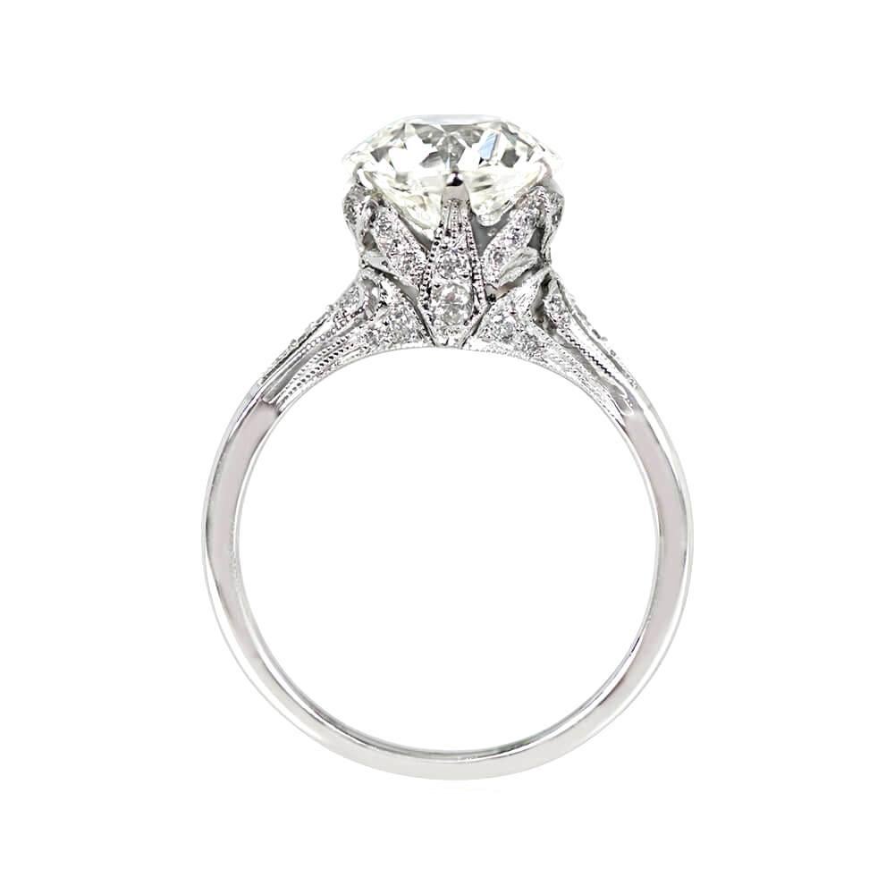 This is a stunning platinum ring with a 2.88 carat old European cut diamond, K color, and VS1 clarity set in prongs. The shoulders, basket, and under-gallery are adorned with additional old European cut diamonds totaling around 0.28 carats. The ring