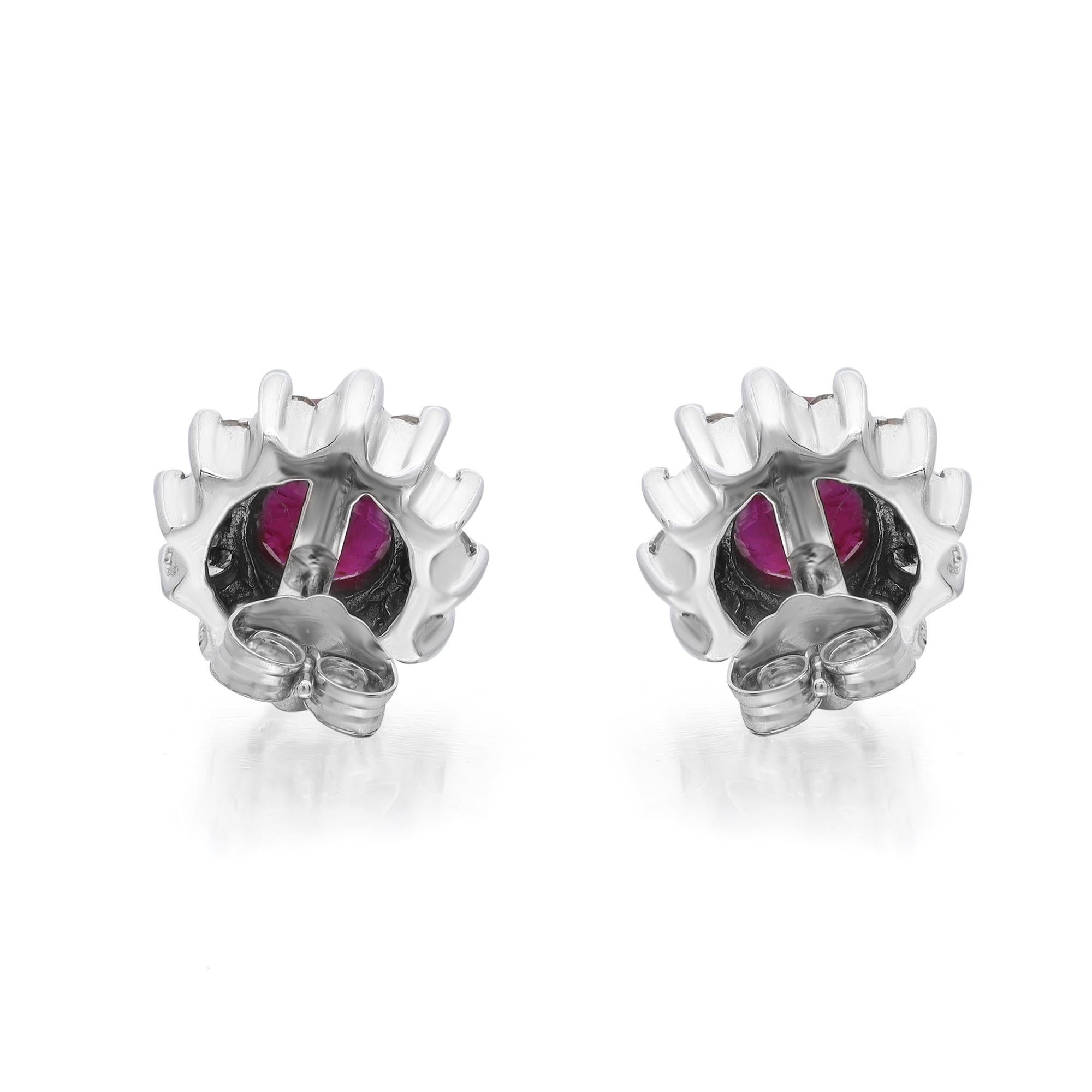 These stunning Ruby and diamond stud earrings are crafted in 14k white gold. Showcases prong set oval shape Rubies weighing 2.88 carats with round brilliant cut diamonds weighing 0.72 carat in halo setting. Diamond quality: color M-N and clarity SI.