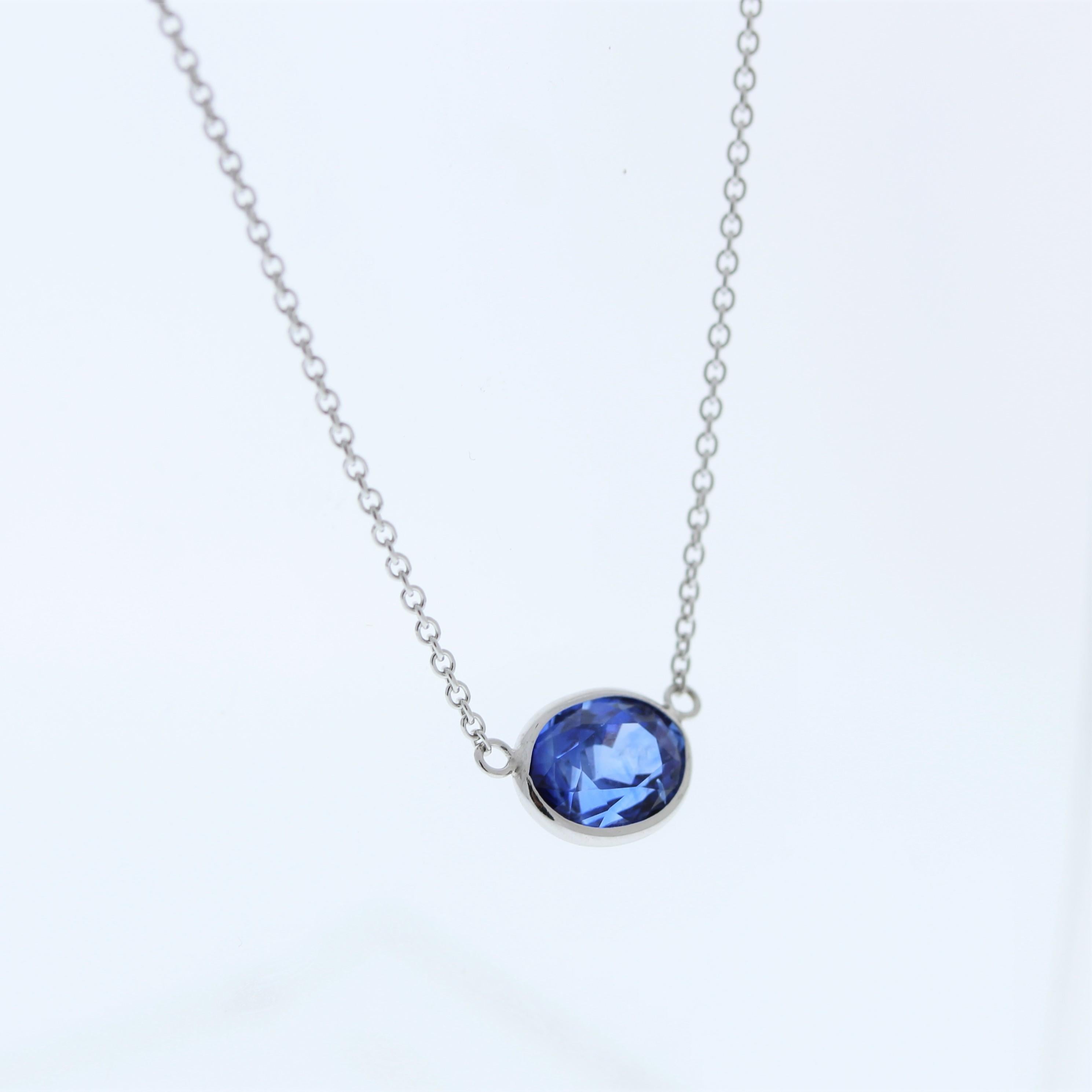 The necklace features a 2.89-carat oval-cut blue sapphire set in a 14 karat white gold pendant or setting. The blue sapphire against the white gold is likely to create an elegant and eye-catching contrast, making this necklace a versatile and