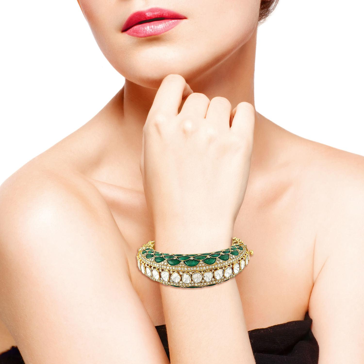 A stunning bangle bracelet handmade in 14K gold.  It is set in 28.95 carats emerald and 11.85 carats rose cut diamonds. Clasp Closure.

FOLLOW  MEGHNA JEWELS storefront to view the latest collection & exclusive pieces.  Meghna Jewels is proudly