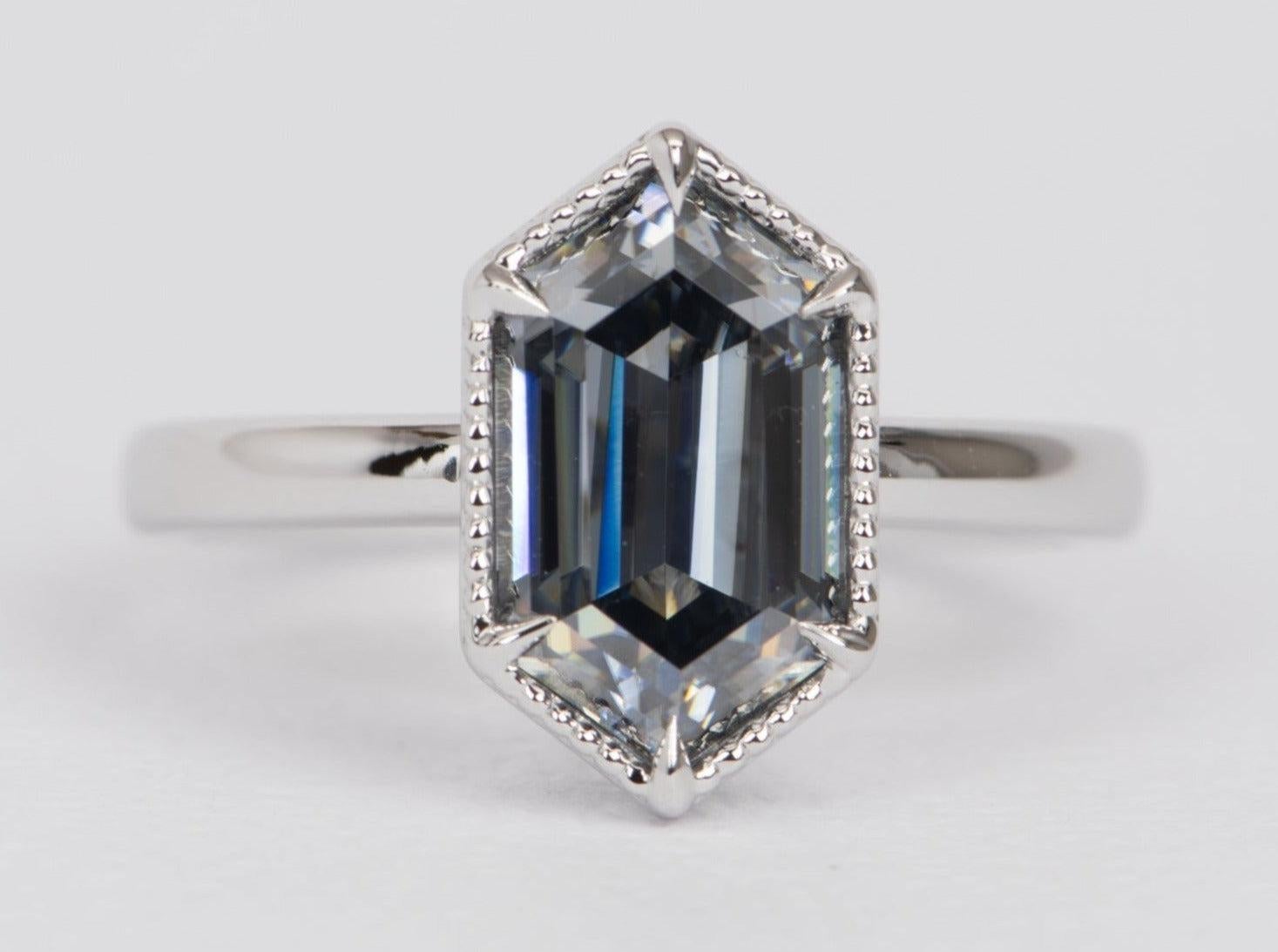 ♥ This is a stunning ring, featuring a large hexagon moissanite
♥ Set in a solid 14K white gold setting
♥ Long V-prong on ends secure the elongated hexagon gemstone; milgrain edge

♥ US Size 7.75 (Free resizing up or down 1 size)
♥ Band width: