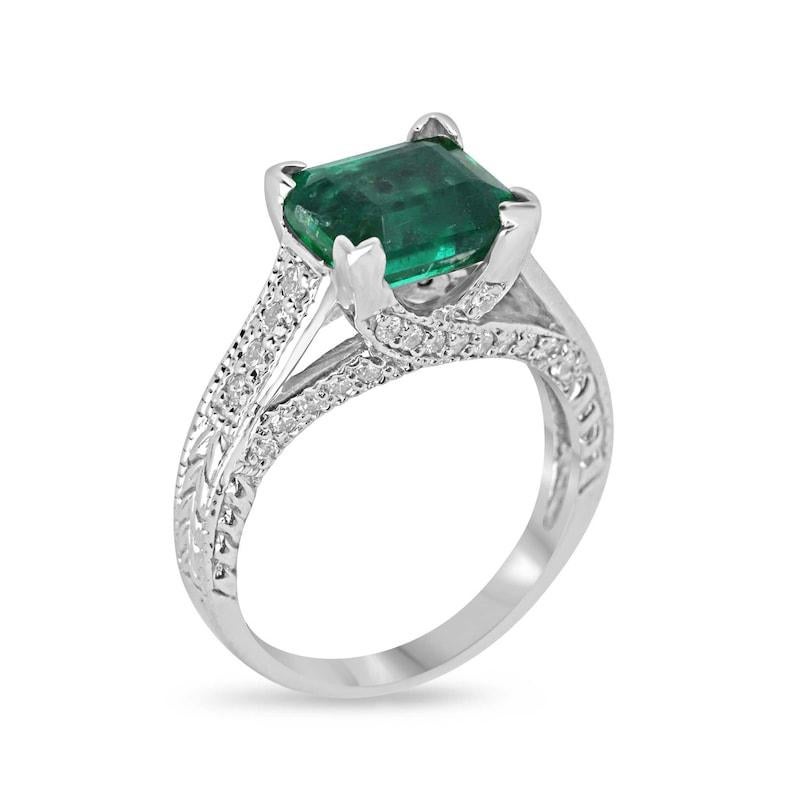 Prepare to embark on a journey of everlasting love with this captivating emerald and diamond engagement ring. Featuring a stunning 2.42-carat emerald cut emerald, its vibrant, rich dark green color and semi-transparent clarity illuminate the depths