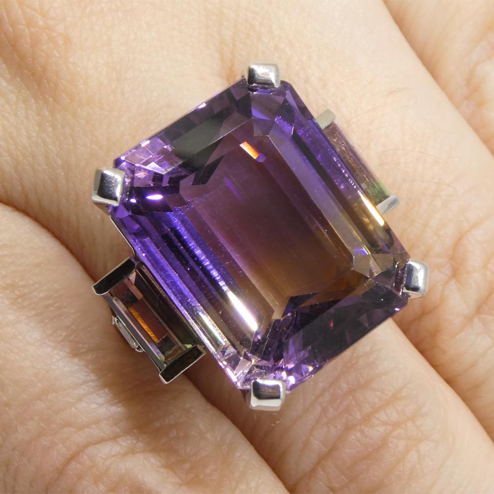 This is a stunning Ametrine, set in 14k White Gold Ring, with Bi-Color Tourmaline and diamonds. This ring is made to exacting standards here in Canada.

Description:

Gem Type: Ametrine
Number of Stones: 1
Weight: 28.39 cts
Measurements: 21.23 x