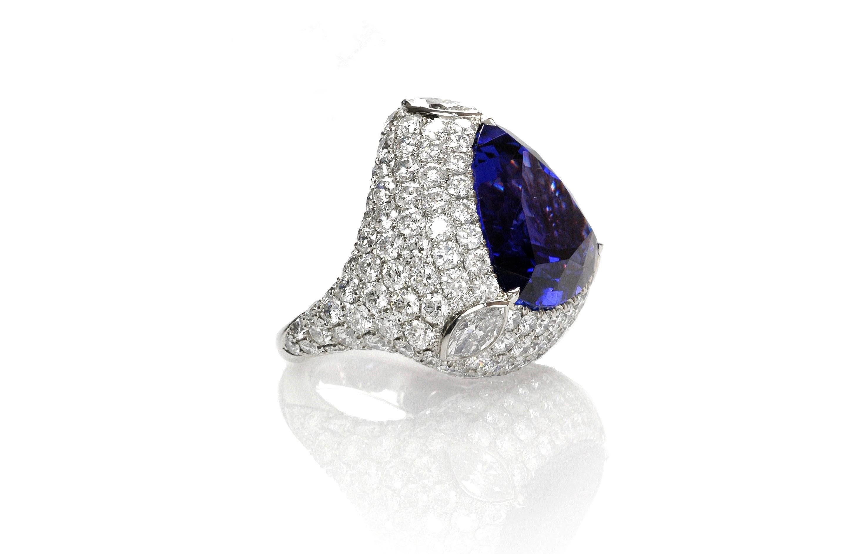 Contemporary design and superior craftsmanship are combined in this impressive ring.  From stone selection to cutting and setting, everything is first rate and it shows.

1  tanzanite 28.38cts
3 marquise cut diamonds total weight 1.14cts
163 round