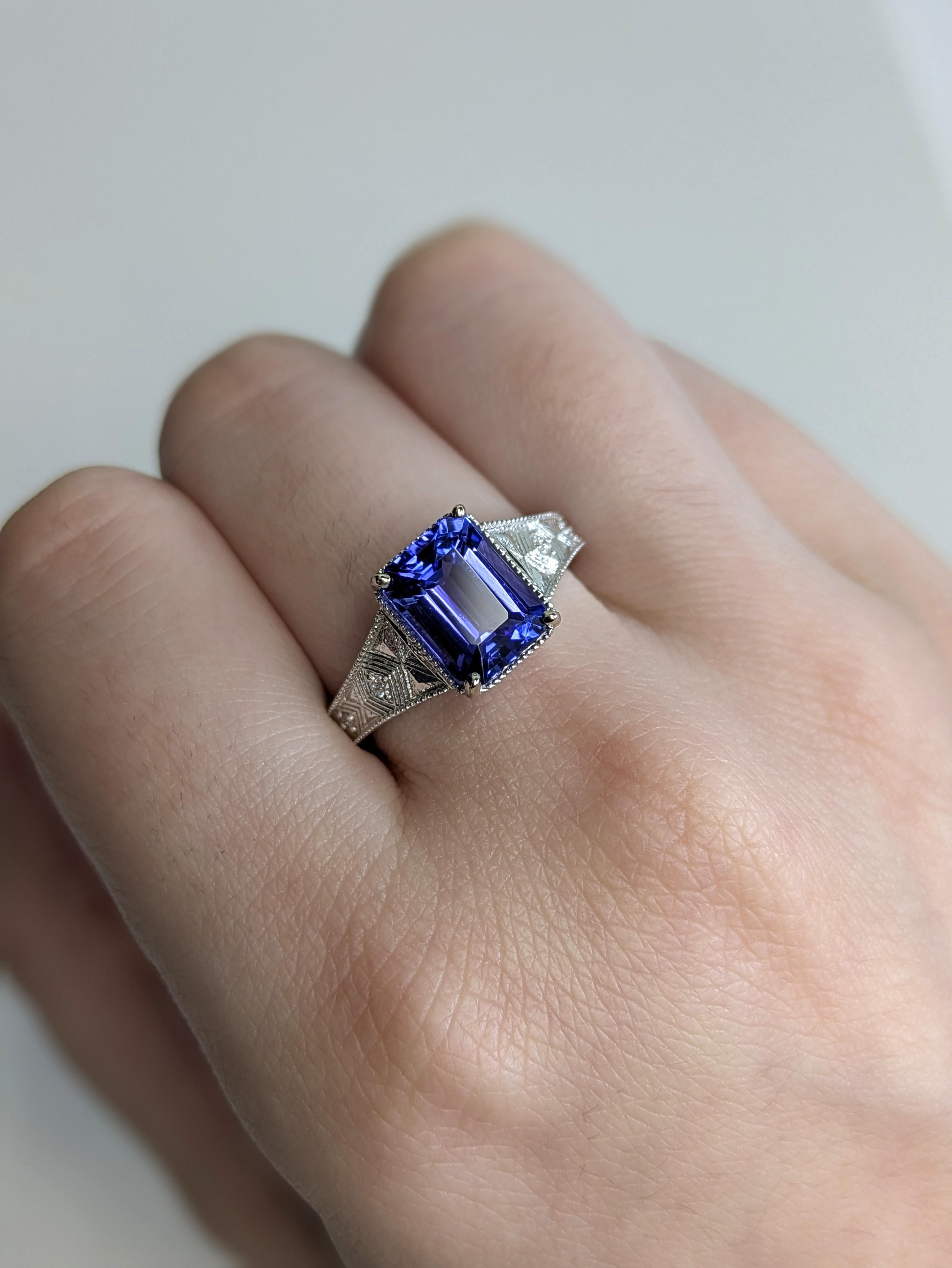 Make a statement with this 2.83ct Tanzanite ring in 14K white gold. Earth-mined diamonds add sparkle, while the broad, tapered shank with textured finish and milgrain accents gives it timeless depth and character.

