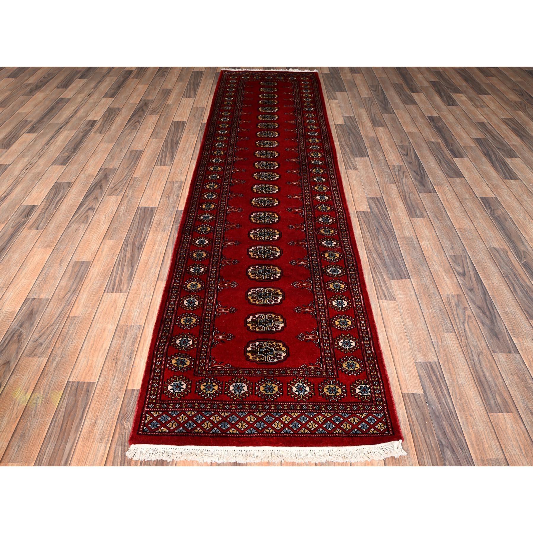 Berry Red, Soft and Shiny Wool, Princess Bokara with Geometric Medallions, Hand Knotted, Runner, Oriental Rug
Primary materials: Wool
Latex: No Pile 
height: 0.25 Inches
Style: Traditional
Primary color: Red
Secondary colors: Light Blue, Yellow,