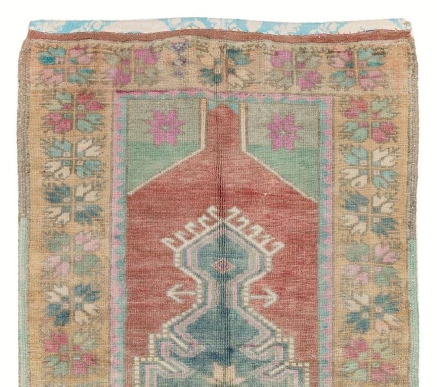 A one of a kind vintage hand-knotted Turkish scatter rug in beautiful soft colors. 
100% Wool with even medium pile. The rug is sturdy and suitable for using on a high foot traffic area. 
All our rugs are professionally washed before they make