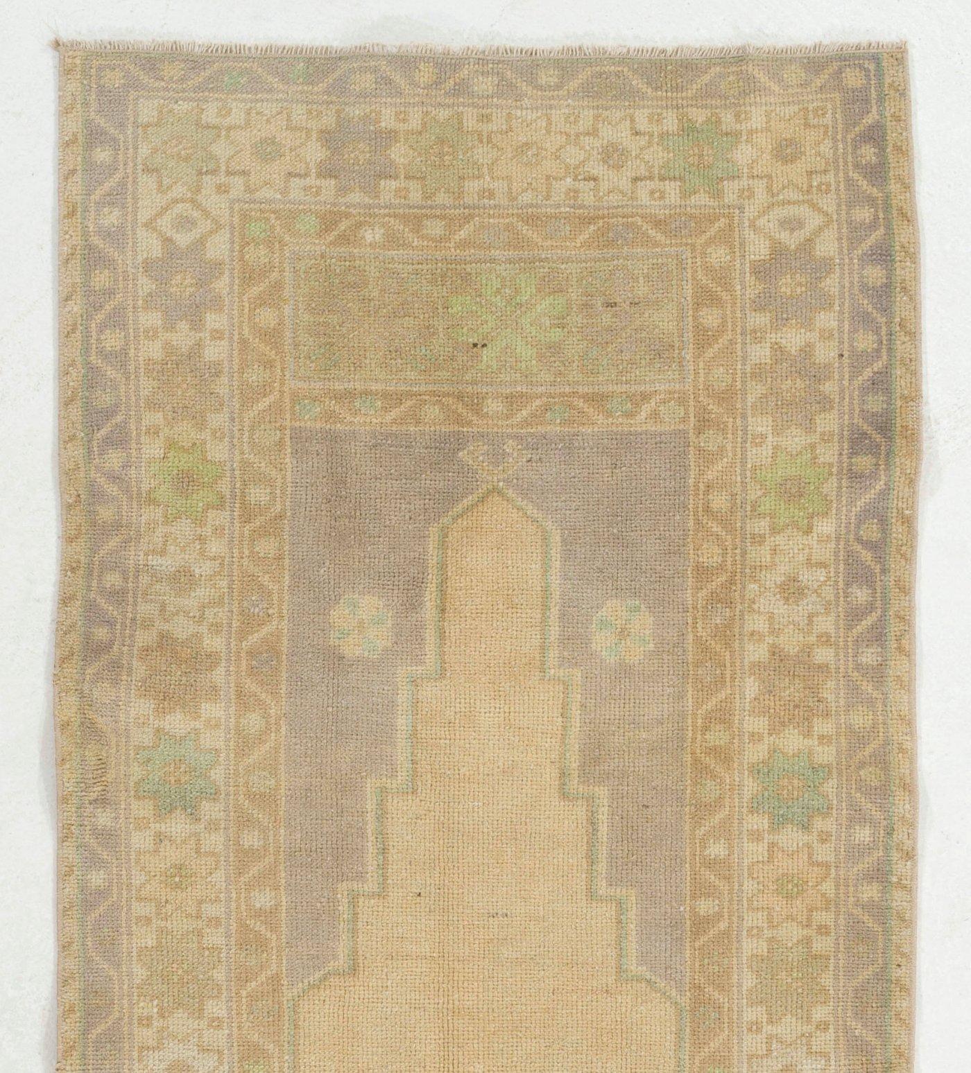 A vintage Turkish accent rug in soft colors. Finely hand-knotted with even medium wool pile on cotton foundation. Very good condition. Sturdy and as clean as a brand new rug (deep washed professionally). Measure: 2.8 x 6.6 ft.
 