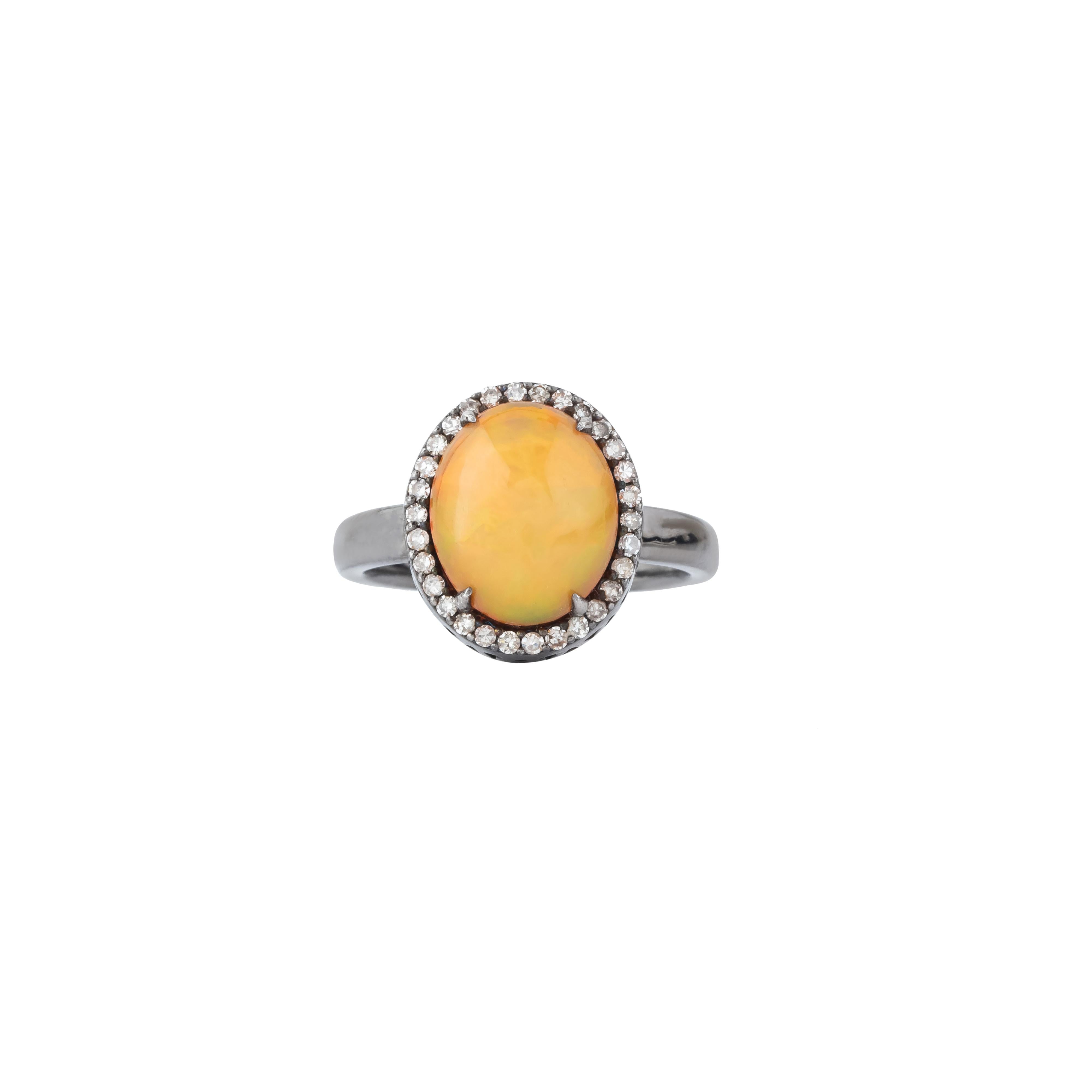 The 2.9 Carat Diamond and Opal Solitaire Ring is a masterpiece of artistry and elegance. At its center, a magnificent opal mesmerizes with its play-of-color, displaying a captivating array of hues that shift and shimmer with every movement. This