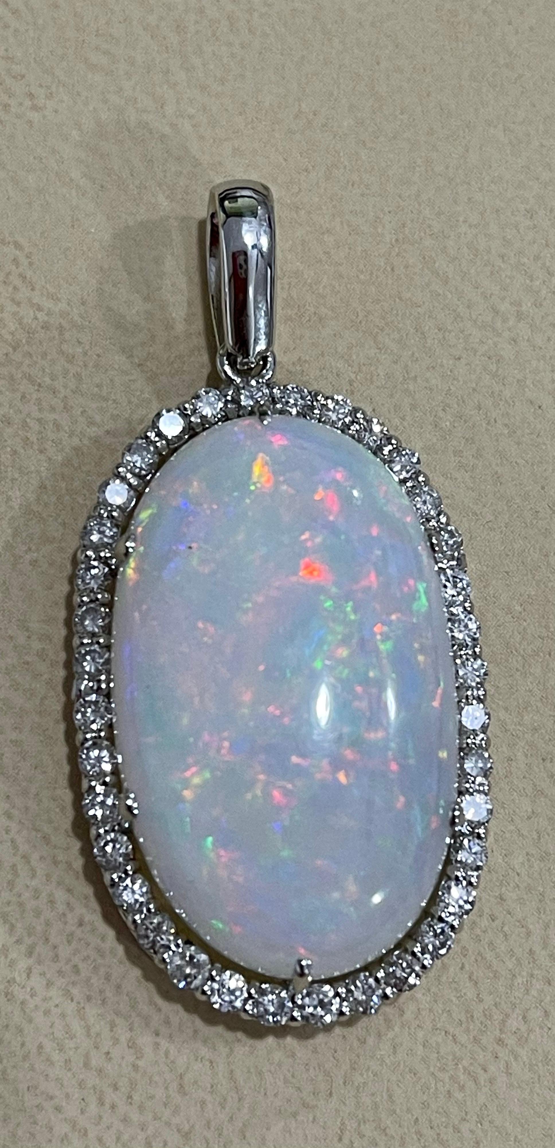 Approximately 29 Carat Oval Ethiopian Opal & Approximately  2.5 Ct  Diamond Pendant/Necklace 14K White Gold 
This spectacular Pendant Necklace consisting of a single long Oval Shape Ethiopian Opal Approximately 29 Carat. The Opal is surrounded by