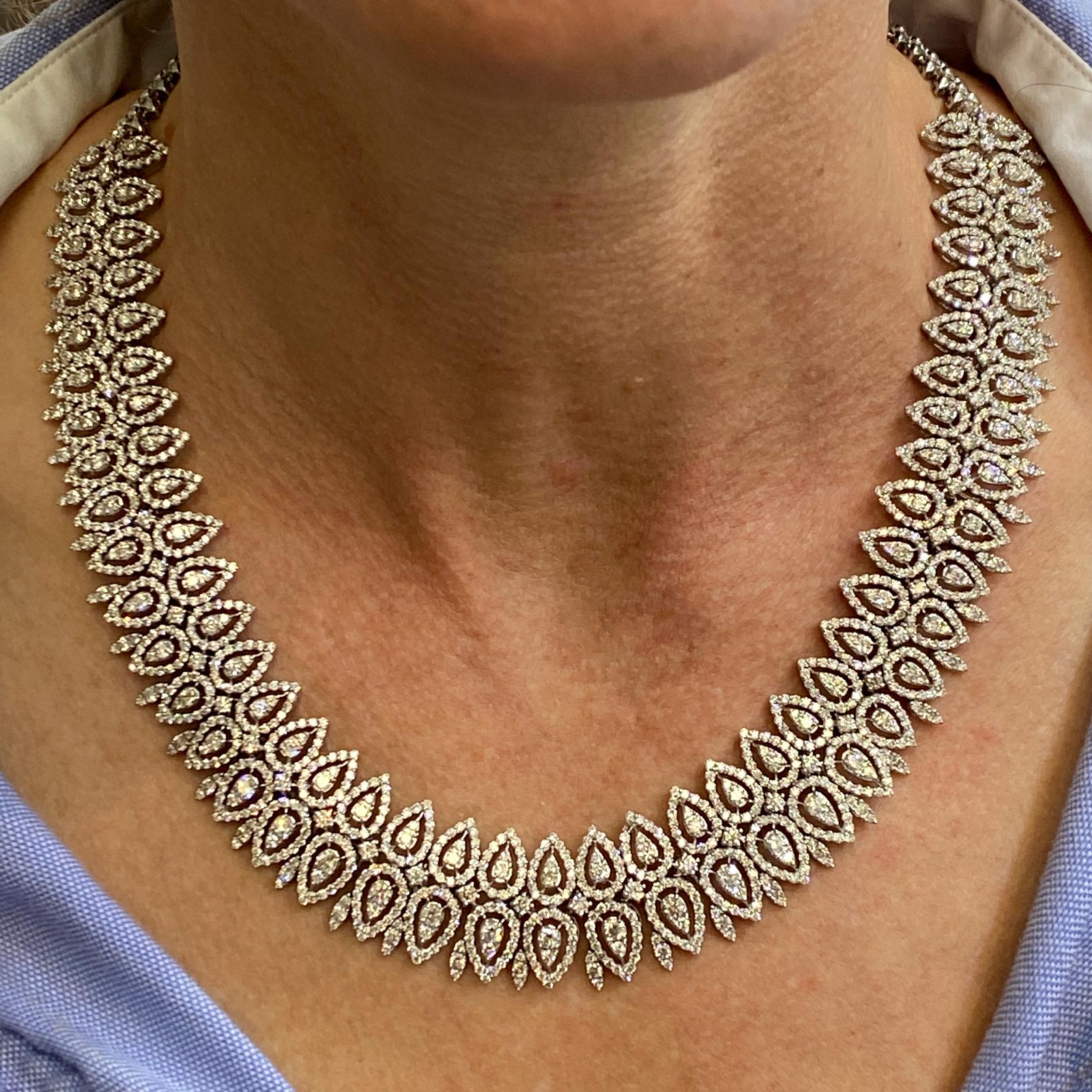 Stunning statement diamond necklace hand crafted in 18 karat white gold. This fabulous necklace features round brilliant cut white diamonds set in a marquise fashion. The diamonds weigh approximately 29 carats and are graded H-I color and