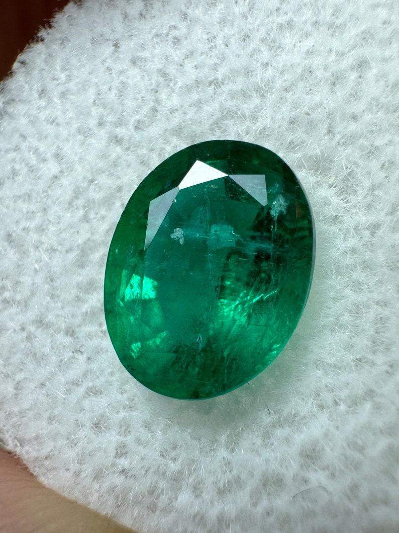 Stone: Emerald
Weight: 2.90-carats
Shape: Oval Cut
Clarity: Transparent
Luster: Very Good
Color: Deep Green
Measurements: 10.11mm x 7.95mm x 5.73mm
Geographic Origin: Zambia
Treatment: Natural, Oiling

Comments: Due to their growth conditions in