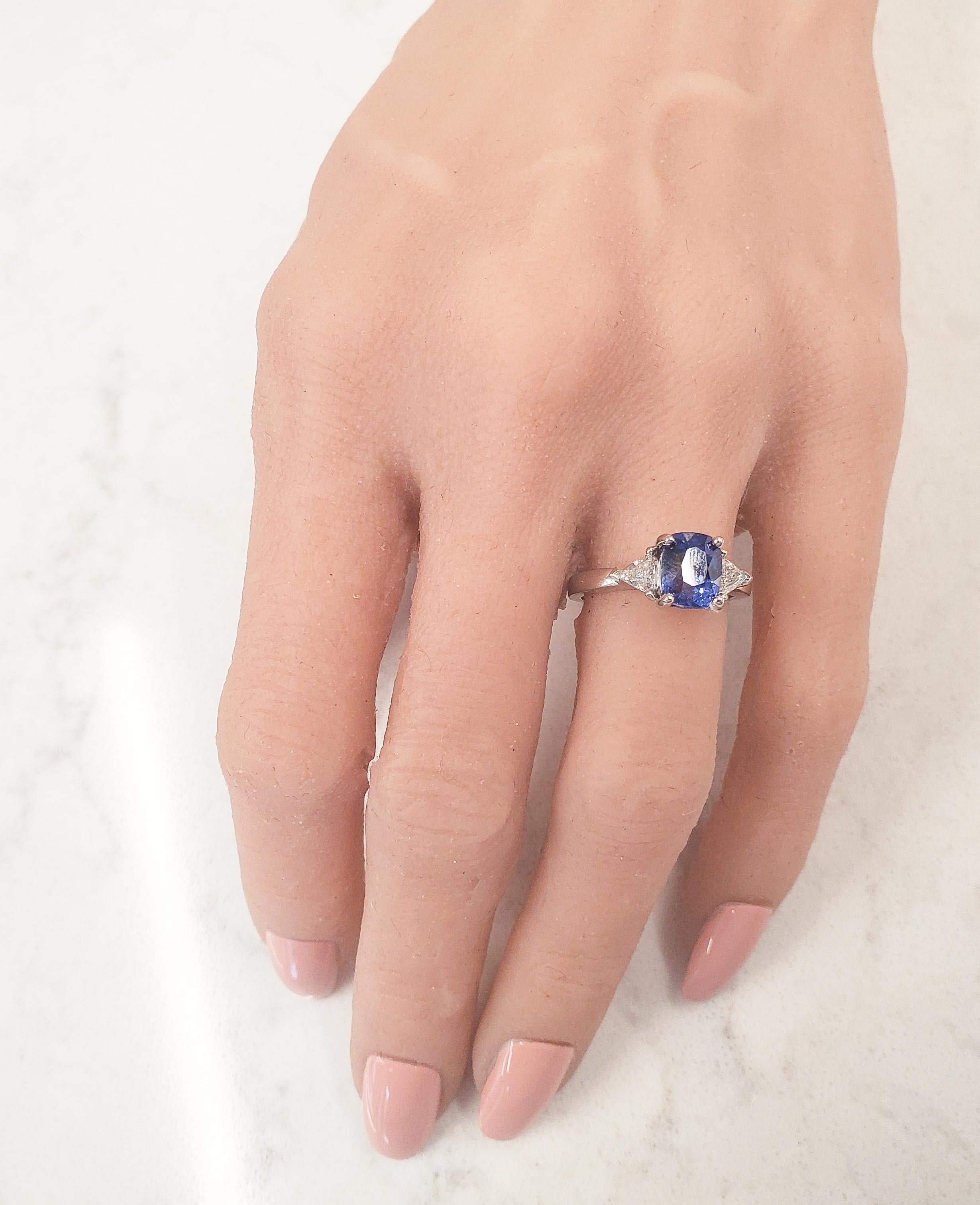 Vibrant pops of color and scintillation are on full display with this breathtaking custom made 18 karat white gold cocktail ring. A fine quality cushion-cut sapphire is secured in a four prong setting with a weight of 2.90 carats, displaying a fine