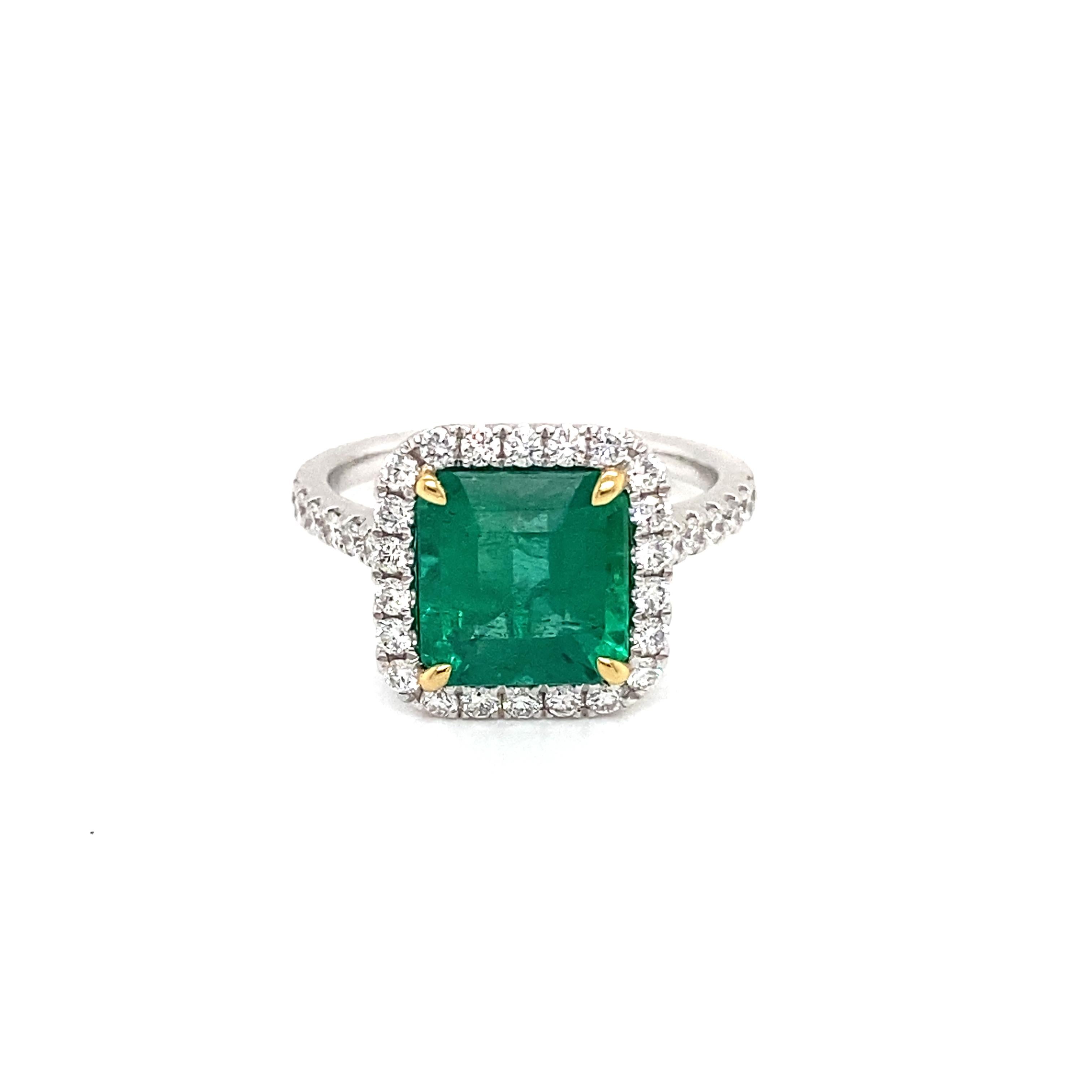 This stunning Cocktail Ring features a beautiful 2.90 Carat Emerald Cut Emerald with a Diamond Halo, that sits on a Diamond Shank. 
This Ring is set in Platinum with 18K Yellow Gold prongs on the center stone. 
Total Diamond Weight = 0.57 carats.