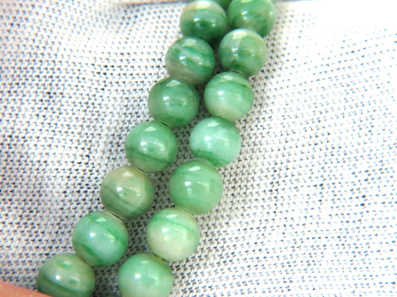 GIA Natural Jade Bead necklace. 

The Natural Translucent Mottled Green 

Report: 5161522933

102 Bead count

10.20 - 4.30mm

26 Inches (wearable length)