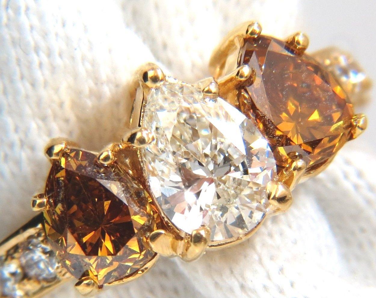 .78ct Natural pear shape diamond & 1.52ct. side fancy color diamond ring,

Center pear shape, brilliant cut.

I-color VS-2 clarity. 

7.4 X 5.2mm



Side (2) pear shape diamonds:

1.52ct.

Natural Fancy Yellow Brown

Vs-2 clarity



Additional 10