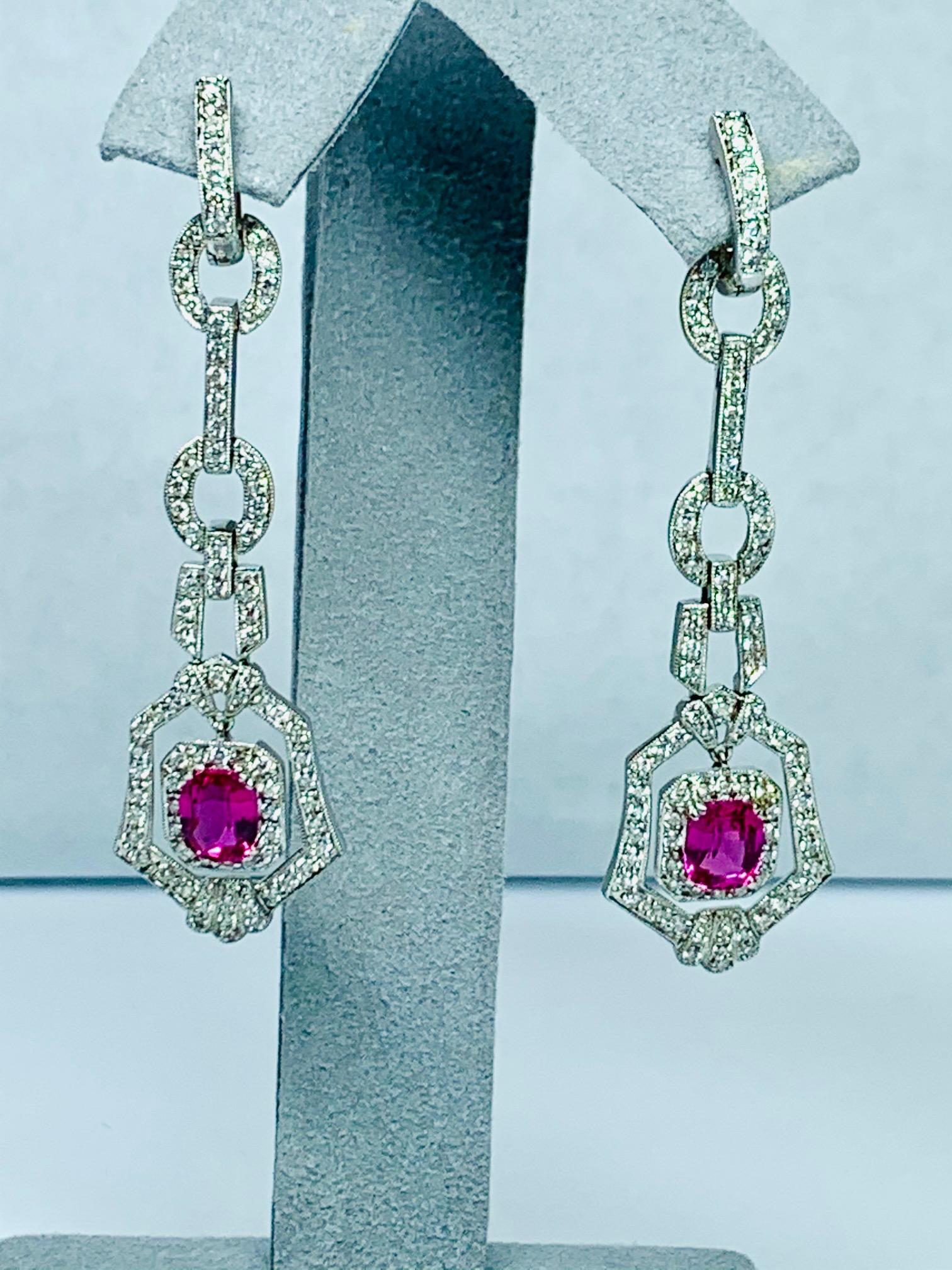 2.90 Carat cushion pink sapphire, heat , set in 18k white gold chandelier /dangle style earrings surrounded with 2.0 carat of white Vs-si1 diamonds .