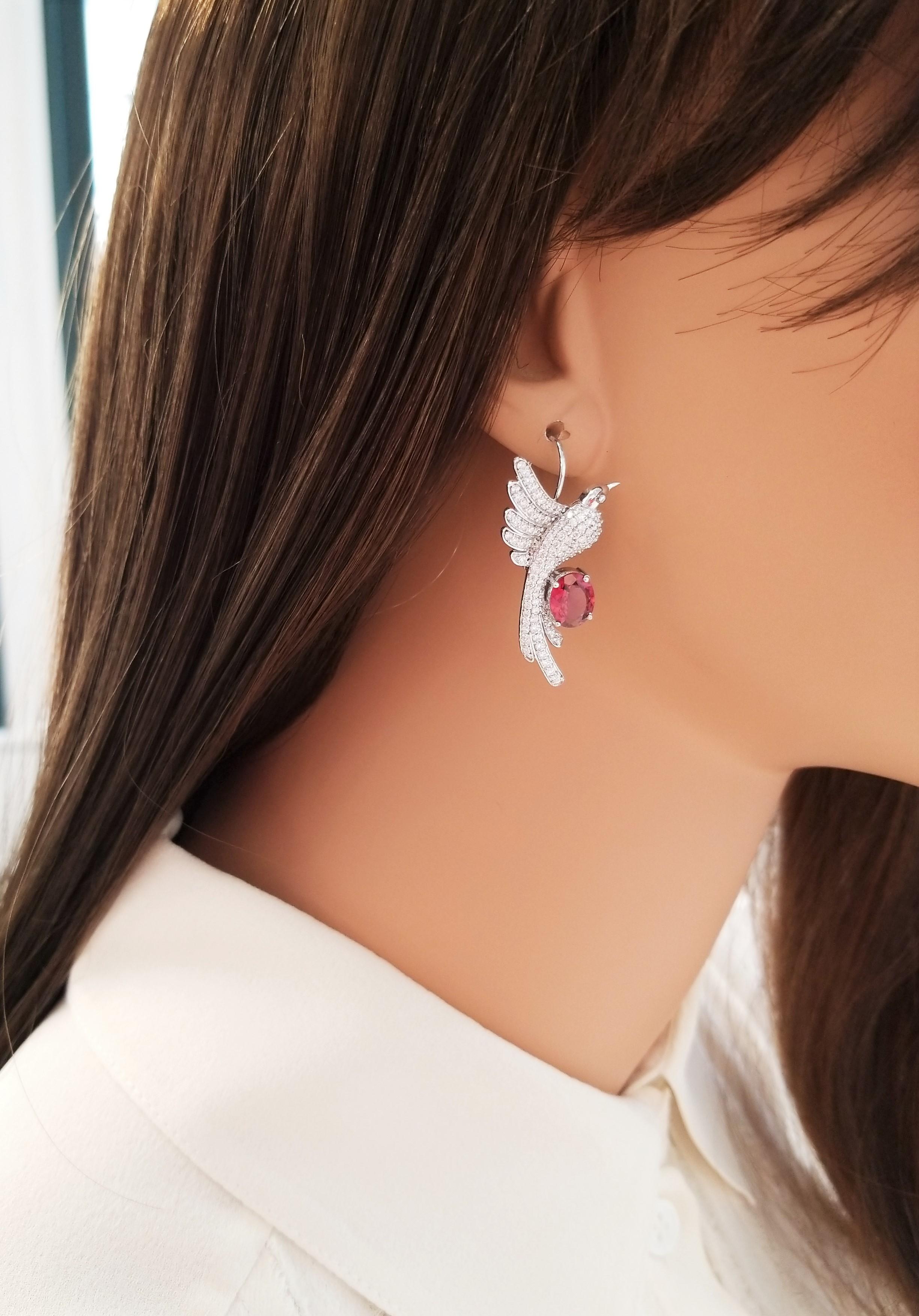 These are flying hummingbirds filled with 226 sparkling round brilliant cut diamonds, pave-set, in a brilliant display totaling 1.84 carats. Oval-shaped vibrant raspberry rubellite tourmalines are prong set with the birds perched atop totaling 2.90