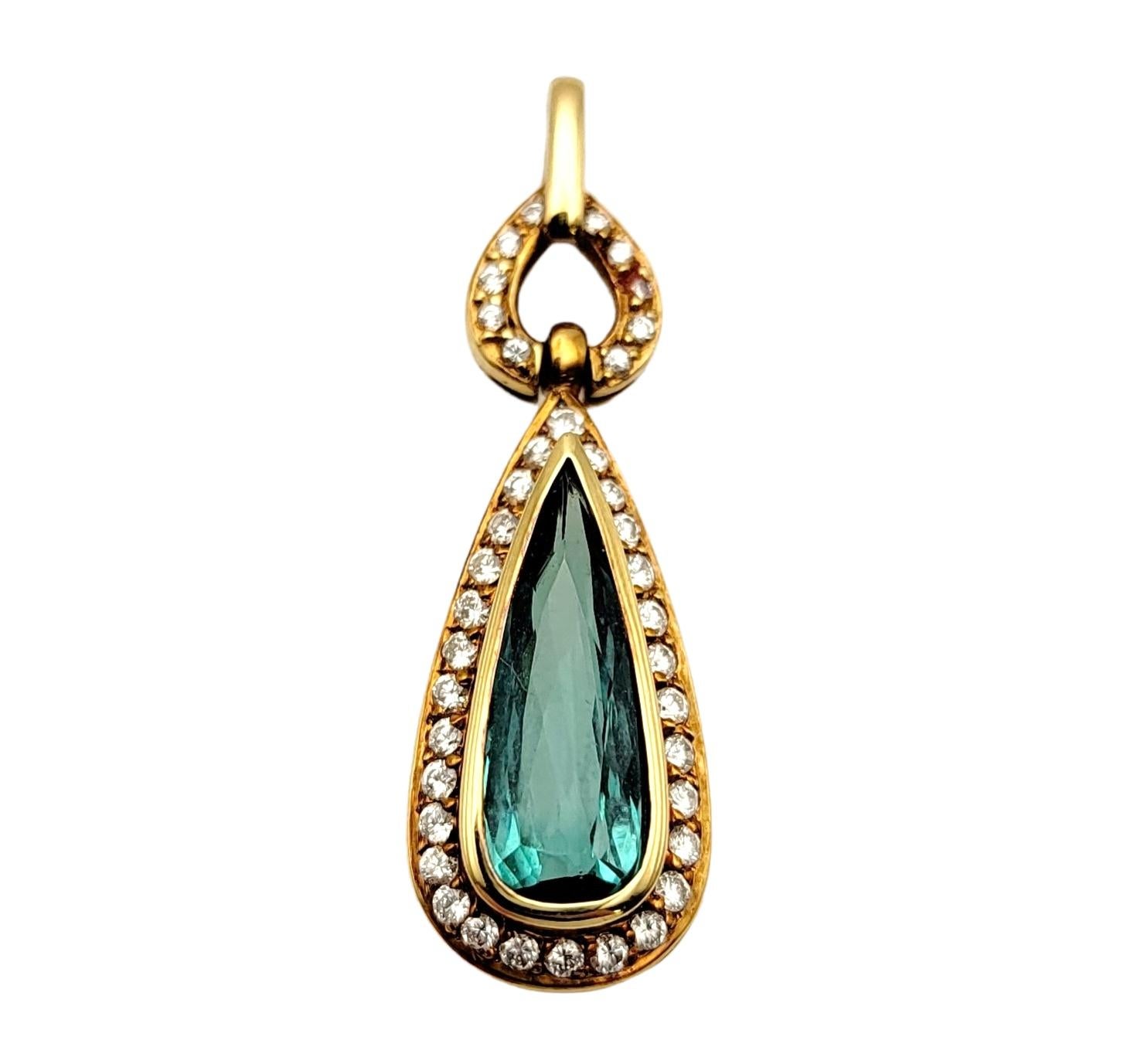 Stunningly beautiful pendant featuring a pear mixed cut tourmaline surrounded by a glittering diamond halo. The stunning bezel set blue-green tourmaline pops elegantly against the warm rose gold setting, while the  dazzling diamond halo really