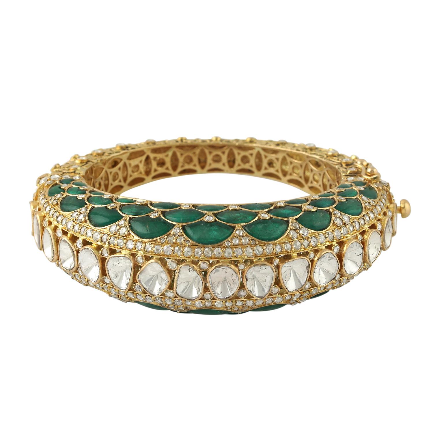 A stunning bangle bracelet handmade in 14K gold.  It is set in 28.95 carats emerald and 11.85 carats rose cut diamonds. Clasp Closure.

FOLLOW  MEGHNA JEWELS storefront to view the latest collection & exclusive pieces.  Meghna Jewels is proudly