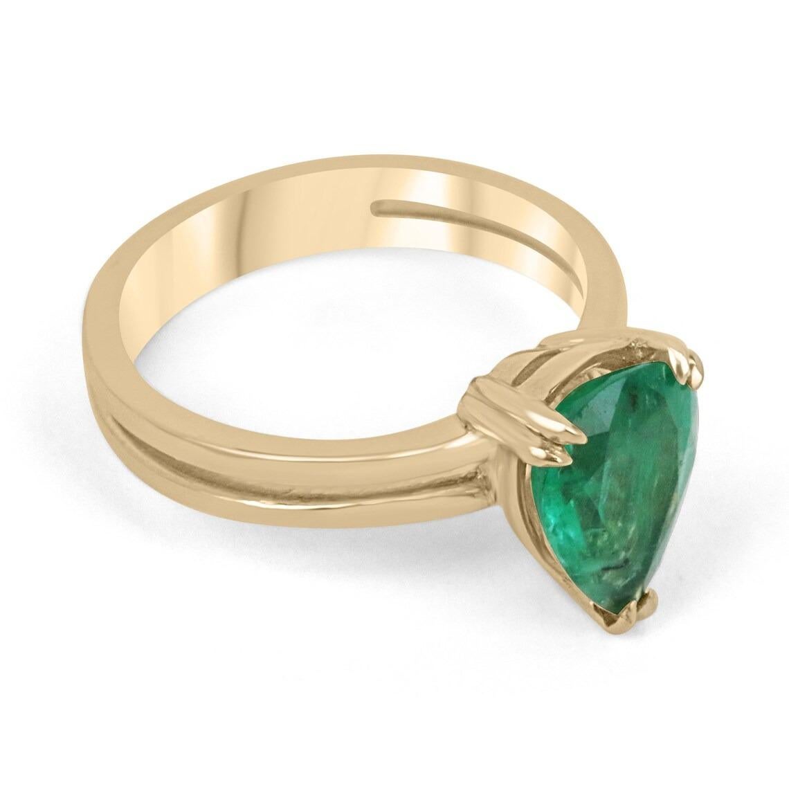 A stunning solitaire emerald right-hand/engagement ring. This edgy piece showcases a distinctive pear-cut emerald from the origin of Zambia. The gemstone showcases a remarkable medium-dark green color, with a subtle yellowish-green hue. Very good