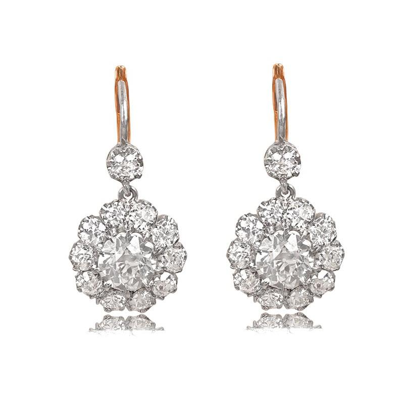 Exuding timeless allure, these diamond cluster earrings are a true masterpiece. The prong-set old European cut diamonds take center stage, boasting a combined weight of 2.90 carats. Complementing the captivating center stones are more old European