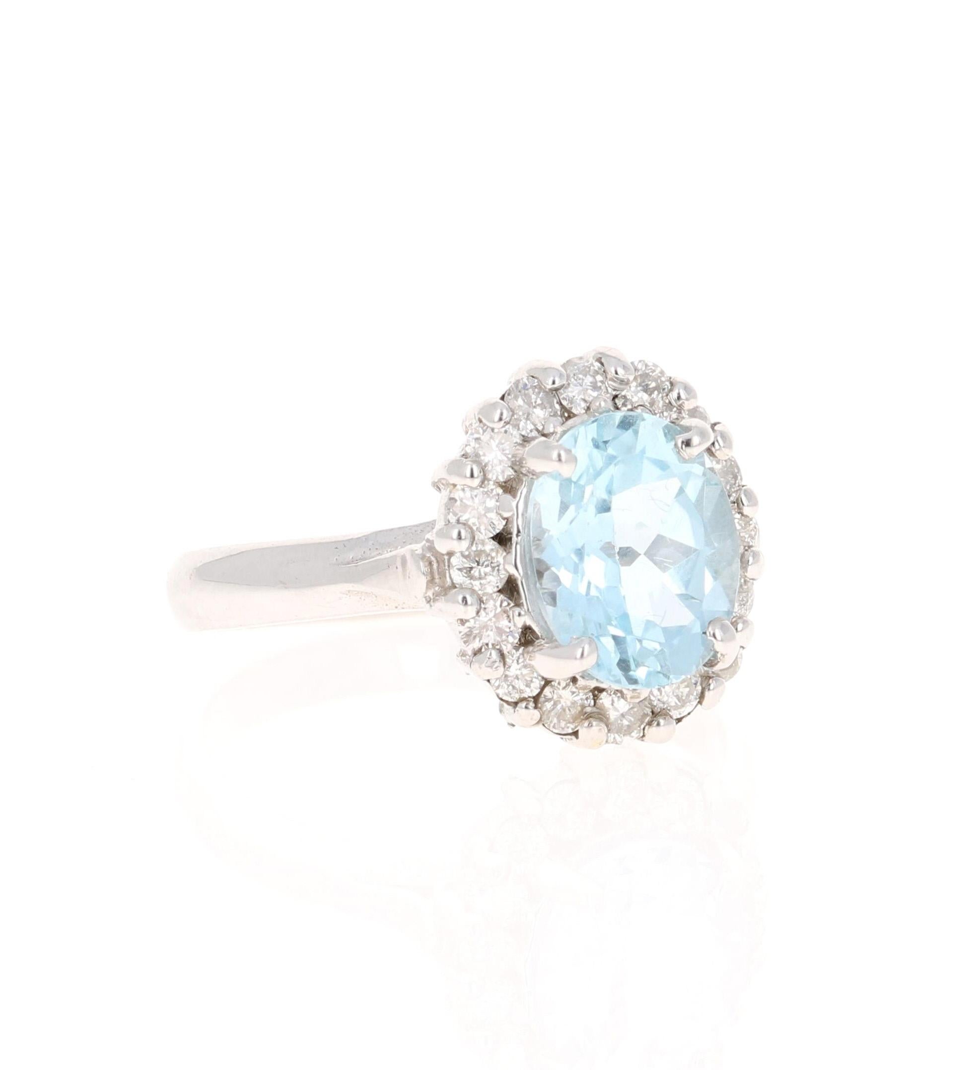 This ring has a pretty 2.31 carat gorgeous Oval Cut Aquamarine set in the center of the ring and is surrounded by 16 Round Brilliant Cut Diamonds that weigh 0.60 carats. The total carat weight of the ring is 2.91 carats. The Clarity of the Diamonds