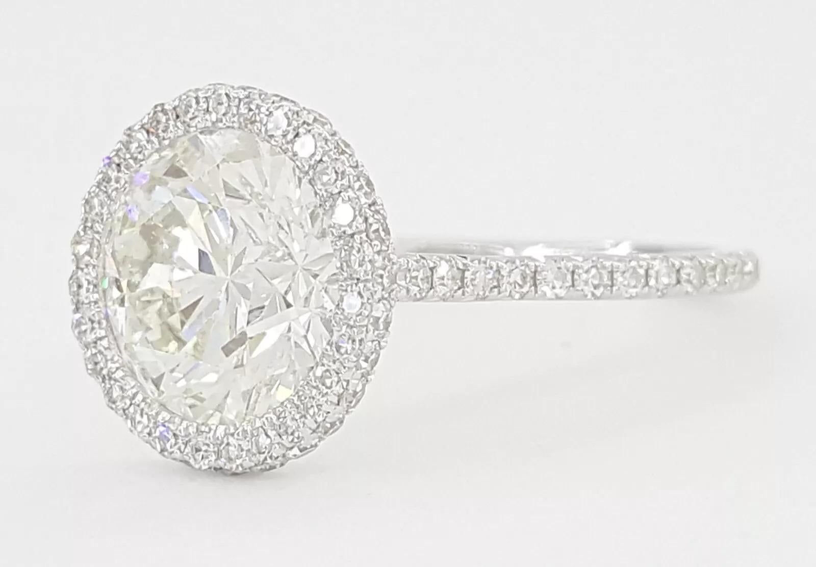 2.91 ct Total Weight 18K White Gold Round Brilliant Cut Diamond Halo Engagement Ring.

The ring weighs 2.1 grams, size 5, the center stone is a Natural Round Brilliant Cut diamond weighing 2.39 ct, I in color, SI2 (the diamond is eye-clean) in