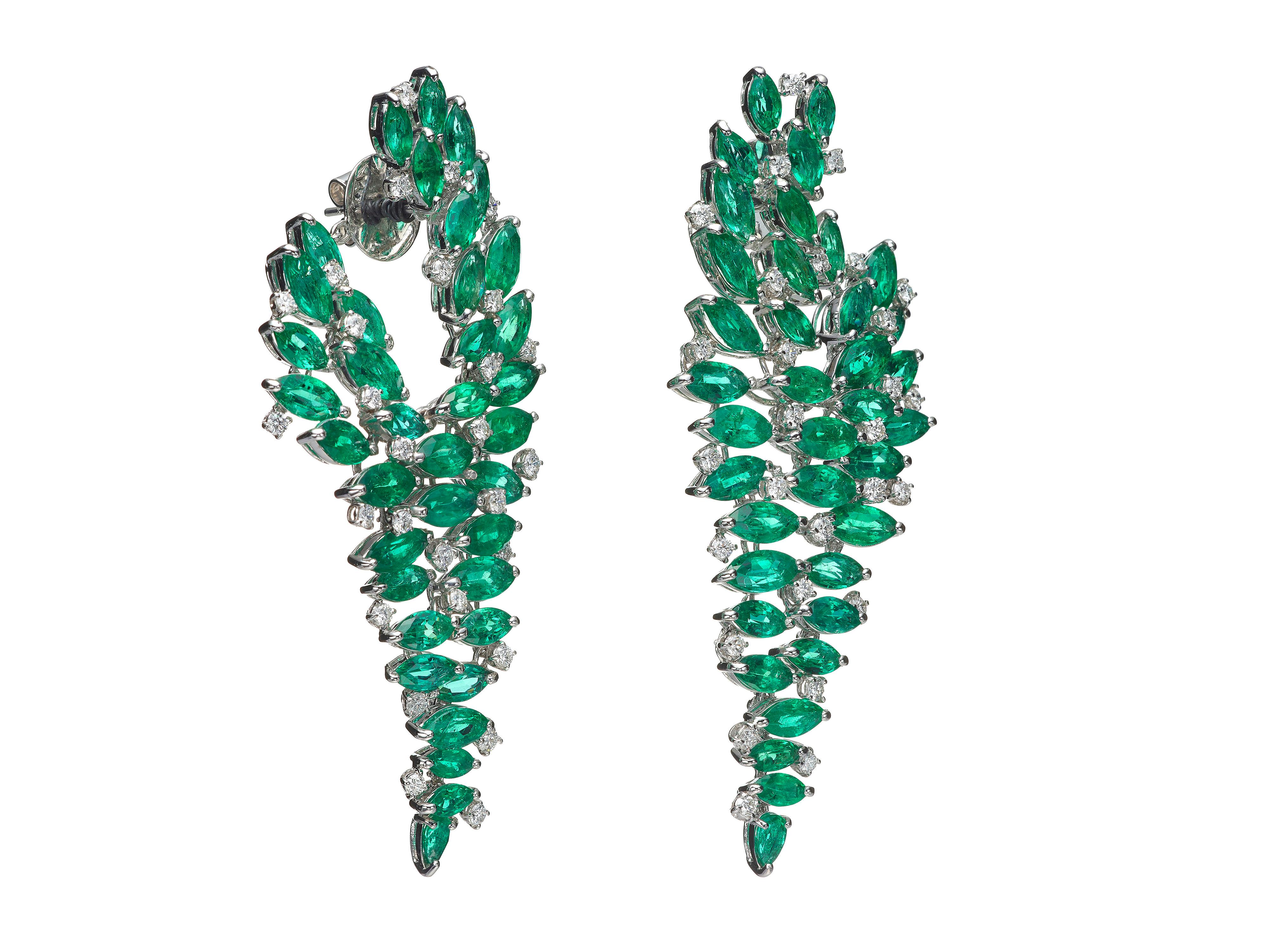 Defined by its firework assortment of striking green marquise and pear shape emeralds, these statement chandelier earrings are encrusted in a three-dimensional drop setting that hits below the jaw.  

Composition:
18K White Gold
2 Pear Emeralds: